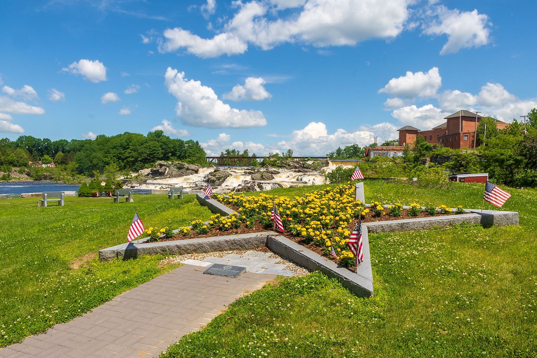 Gold Star Mothers Memorial in Veterans Memorial Park with Lewiston Falls in the background. Editorial credit: Jennifer Yakey-Ault / Shutterstock.com