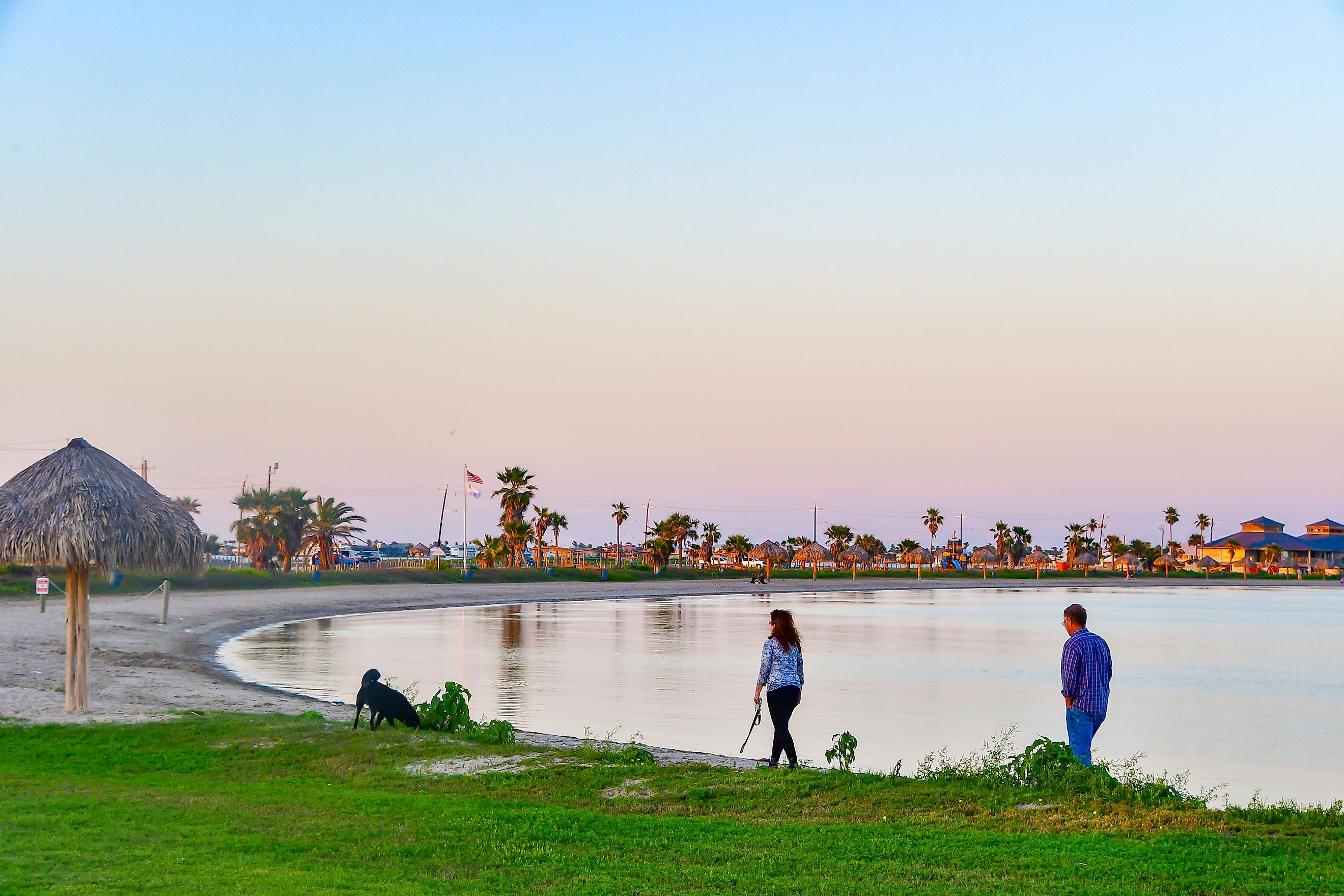 Rockport, Texas / USA - 7 April 2019: Unidentified people enjoying a beautiful sunset at the beach. Editorial credit: Grossinger / Shutterstock.com