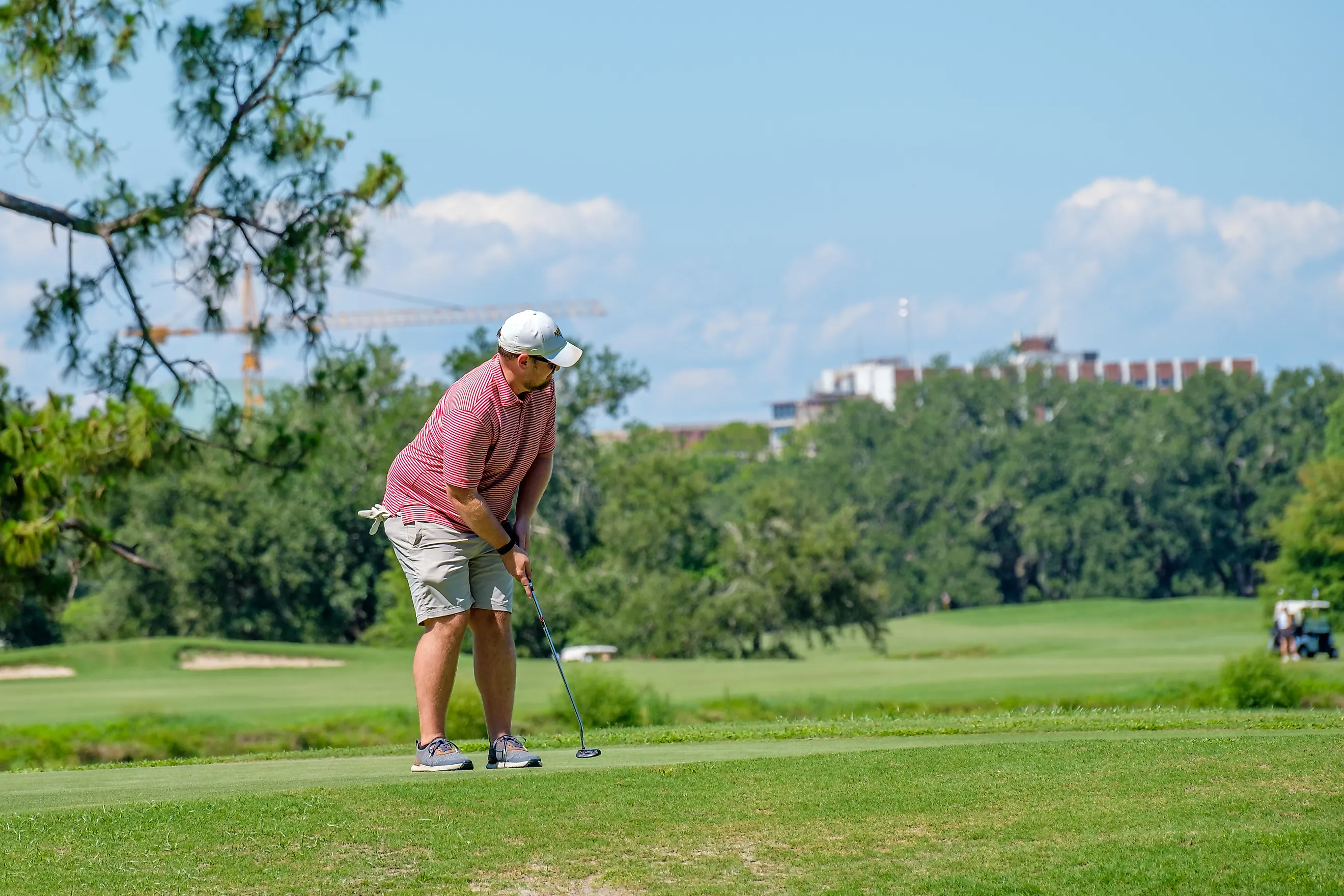 Golfer finishing a putt on the green at Audubon Park Golf Club in New Orleans, Louisiana. Editorial credit: William A. Morgan / Shutterstock.com