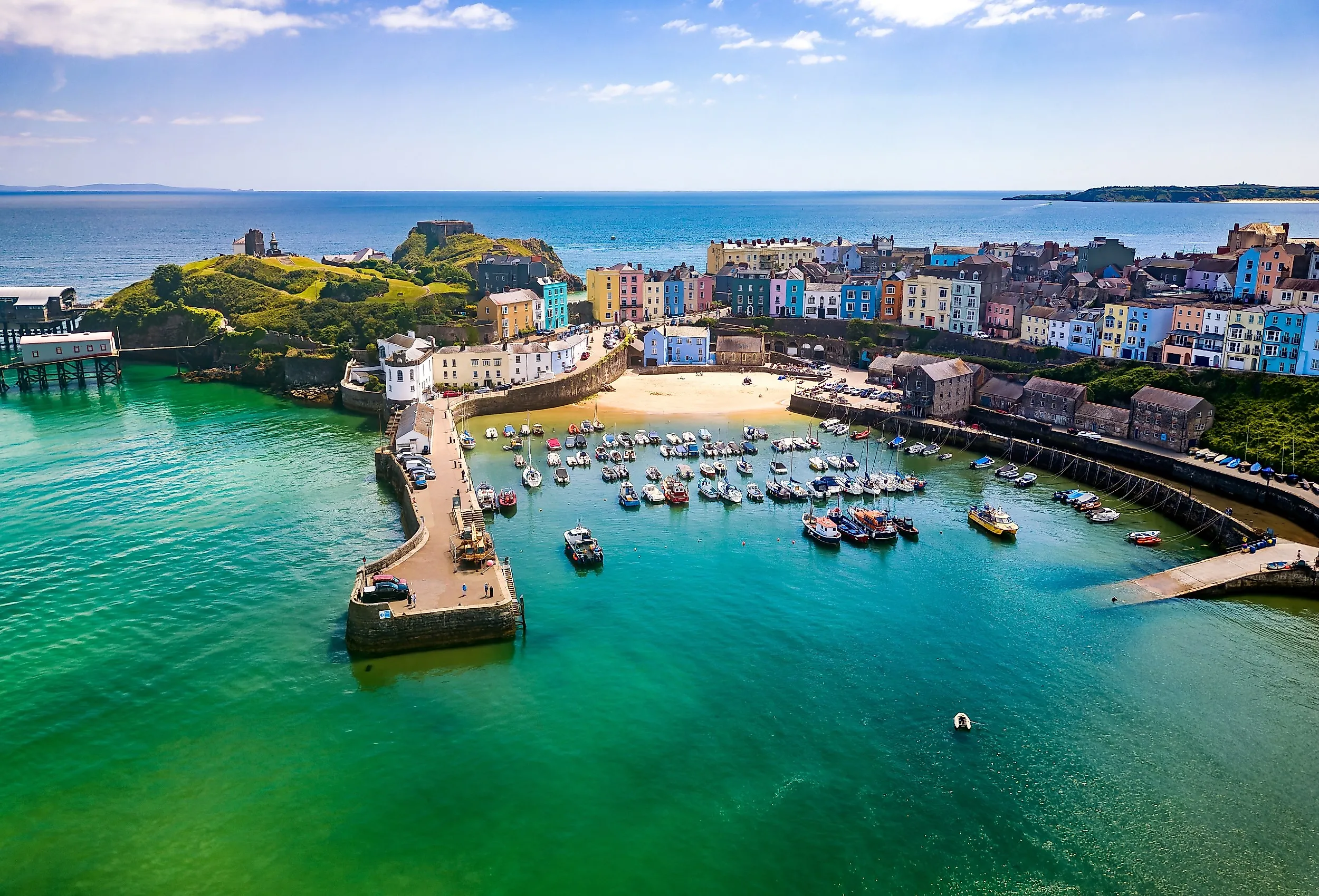 Aerial view of colorful buildings around a small harbor in Tenby, Wales.