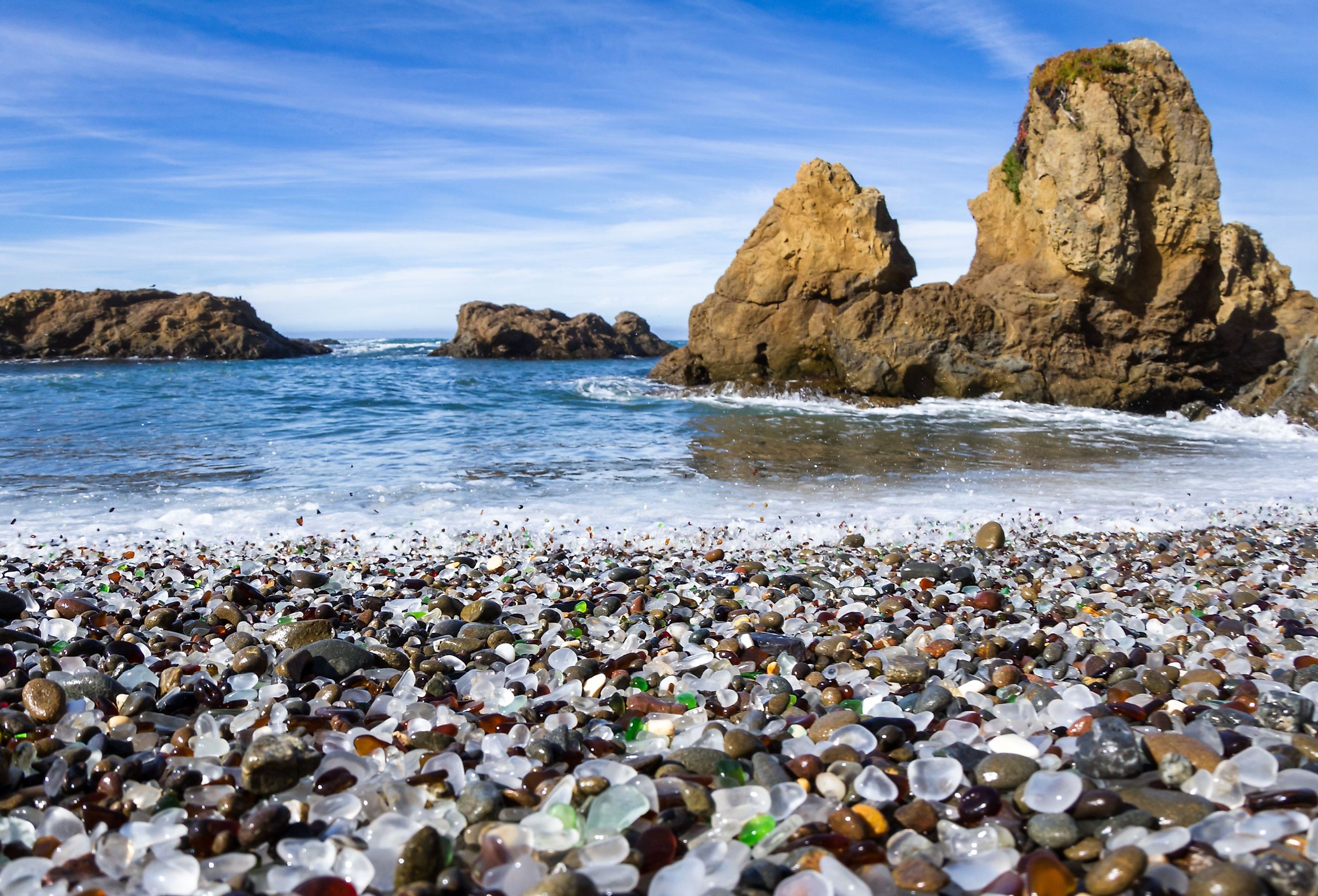 Colorful glass pebbles blanket this beach in Fort Bragg, California.