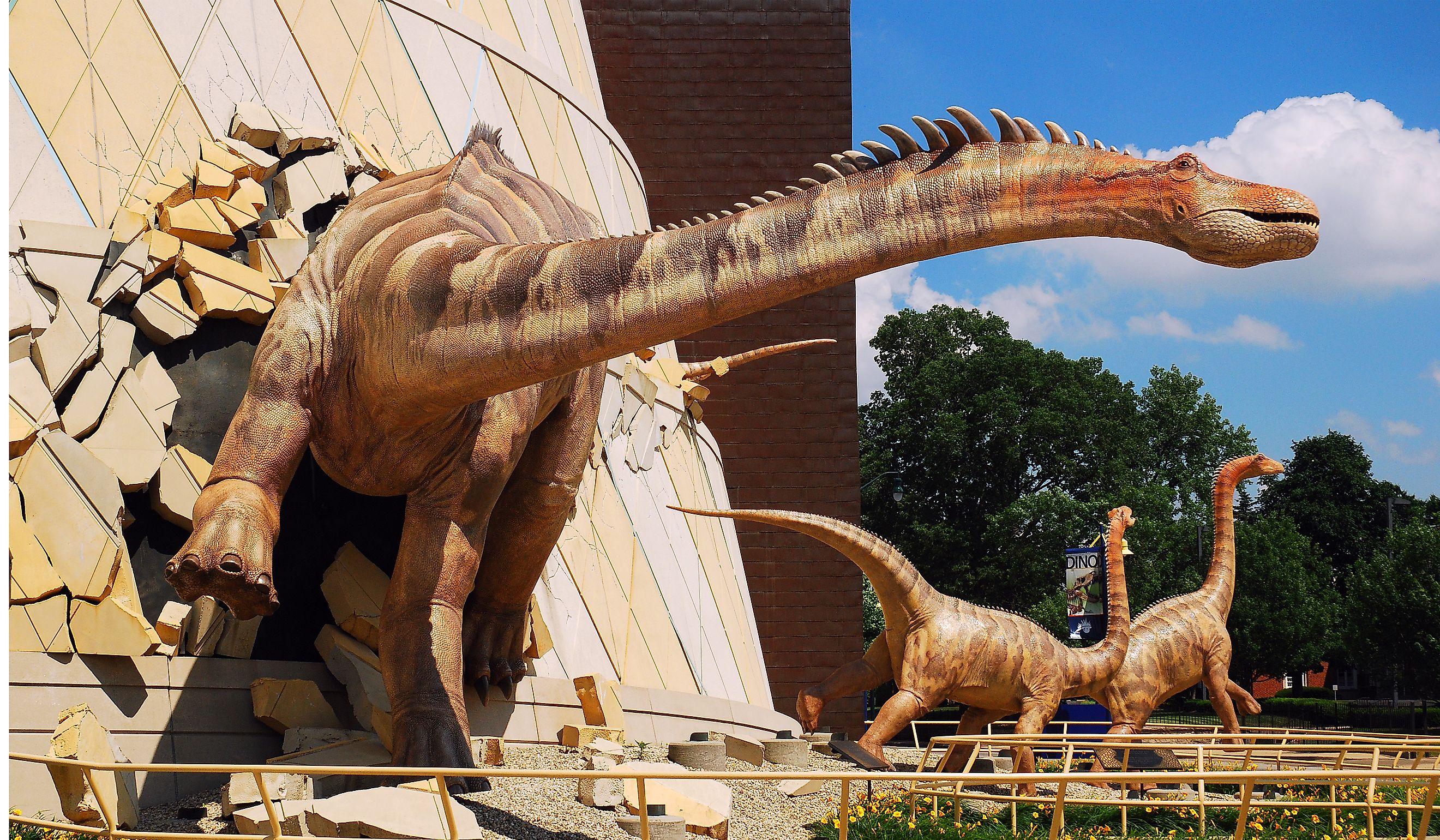 A dinosaur "breaks out" of the wall at the Indianapolis Children's Museum in Indianapolis, Indiana. Editorial credit: James Kirkikis / Shutterstock.com