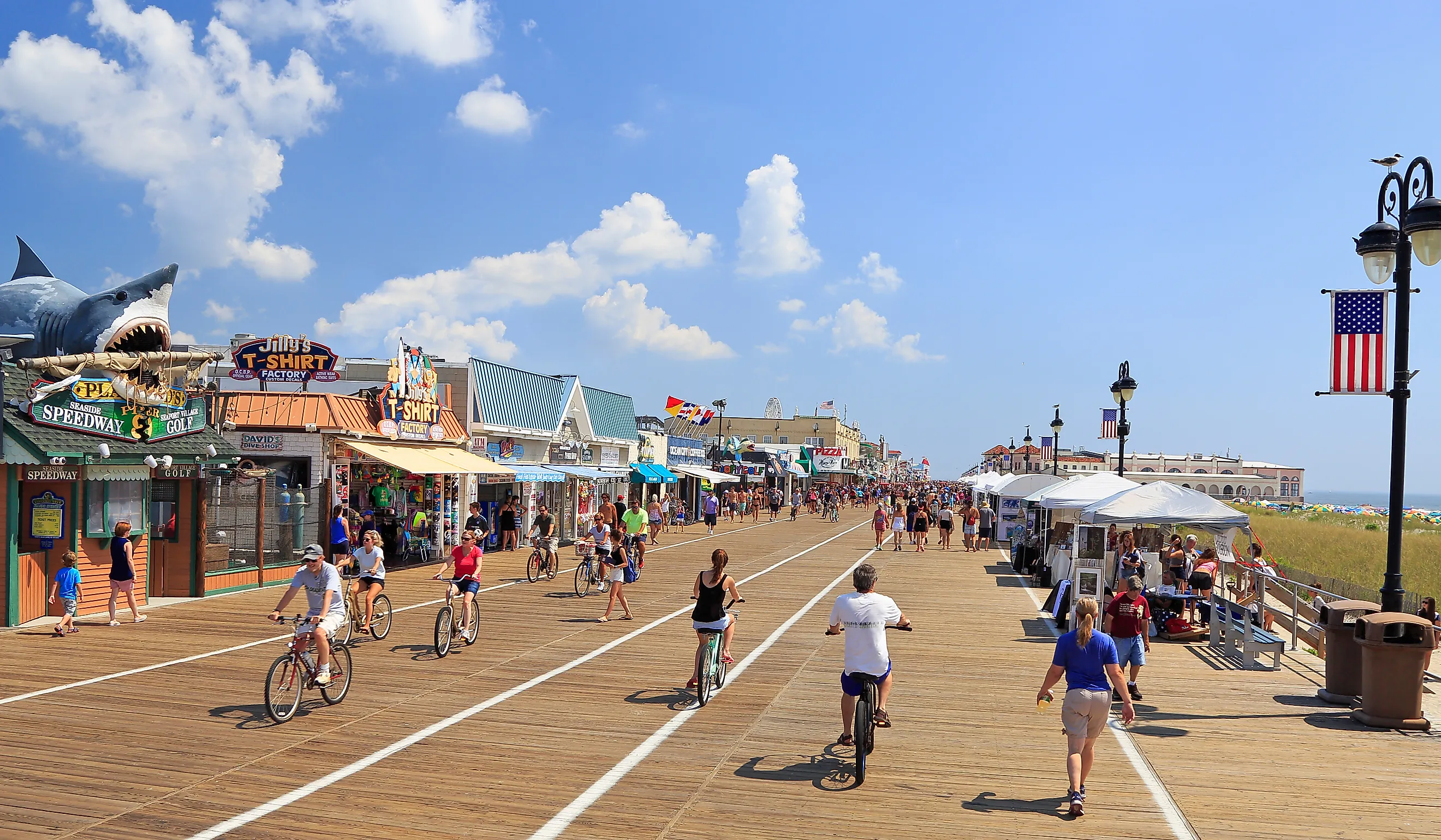People walking and biking along the boardwalk in Ocean City, New Jersey. Editorial credit: Vlad G / Shutterstock.com 