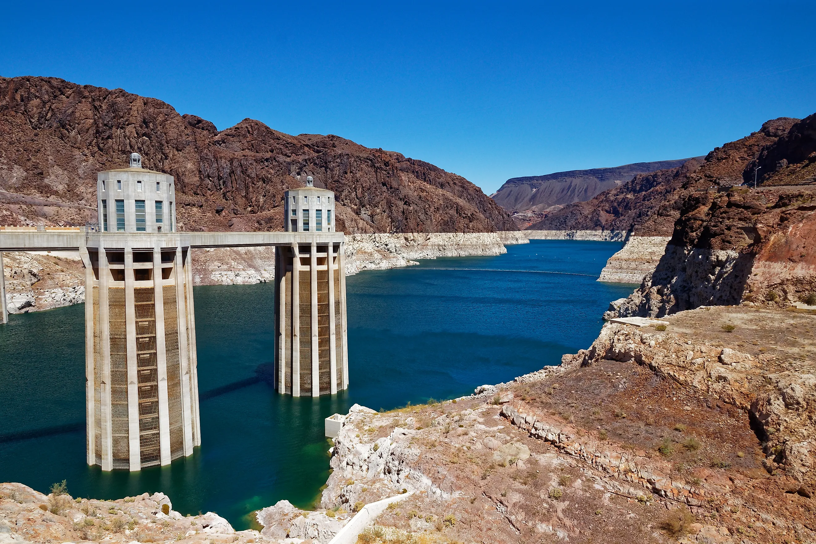 Hoover Dam intake towers in Lake Mead reservoir surrounded by desert canyon walls.