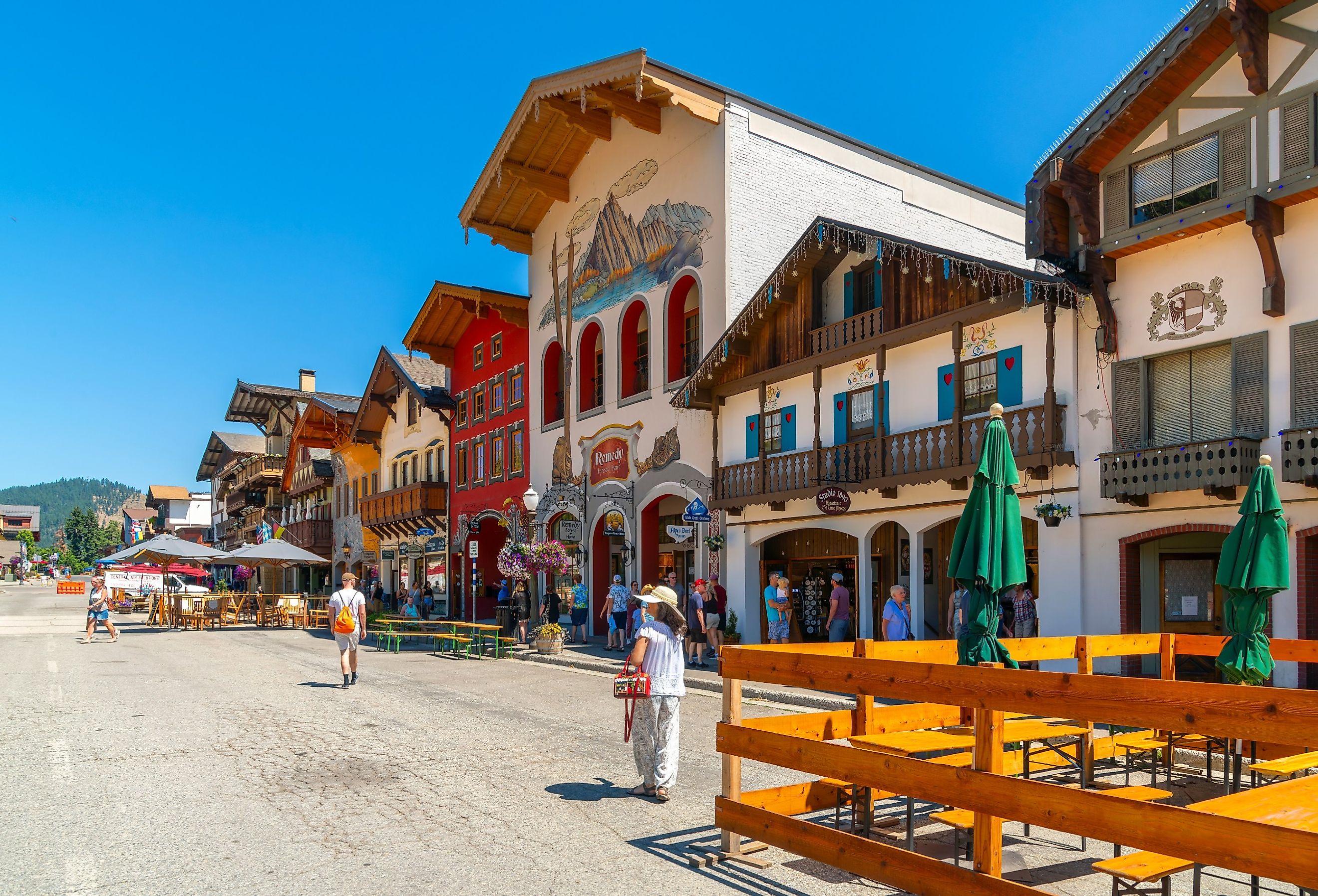 Shops and sidewalk cafes line the quaint Bavarian themed main street of the tourist resort town of Leavenworth, Washington. Image credit Kirk Fisher via Shutterstock