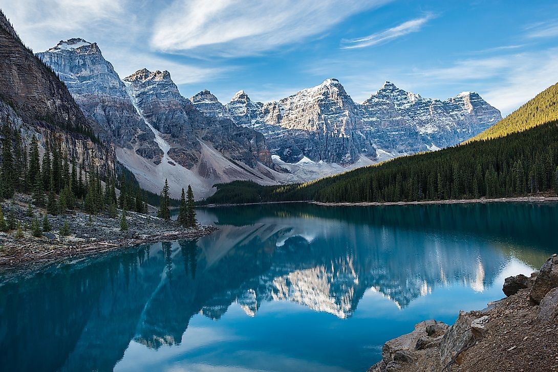 Stunning lakeside view of the Ten Peaks and their reflections off of the water on Moraine Lake.