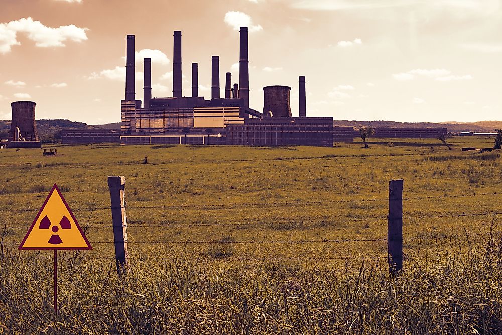 Barbed wire fence and radioactive sign on the nuclear chemical power plant's field in Chernobyl Pripyat atmosphere.
