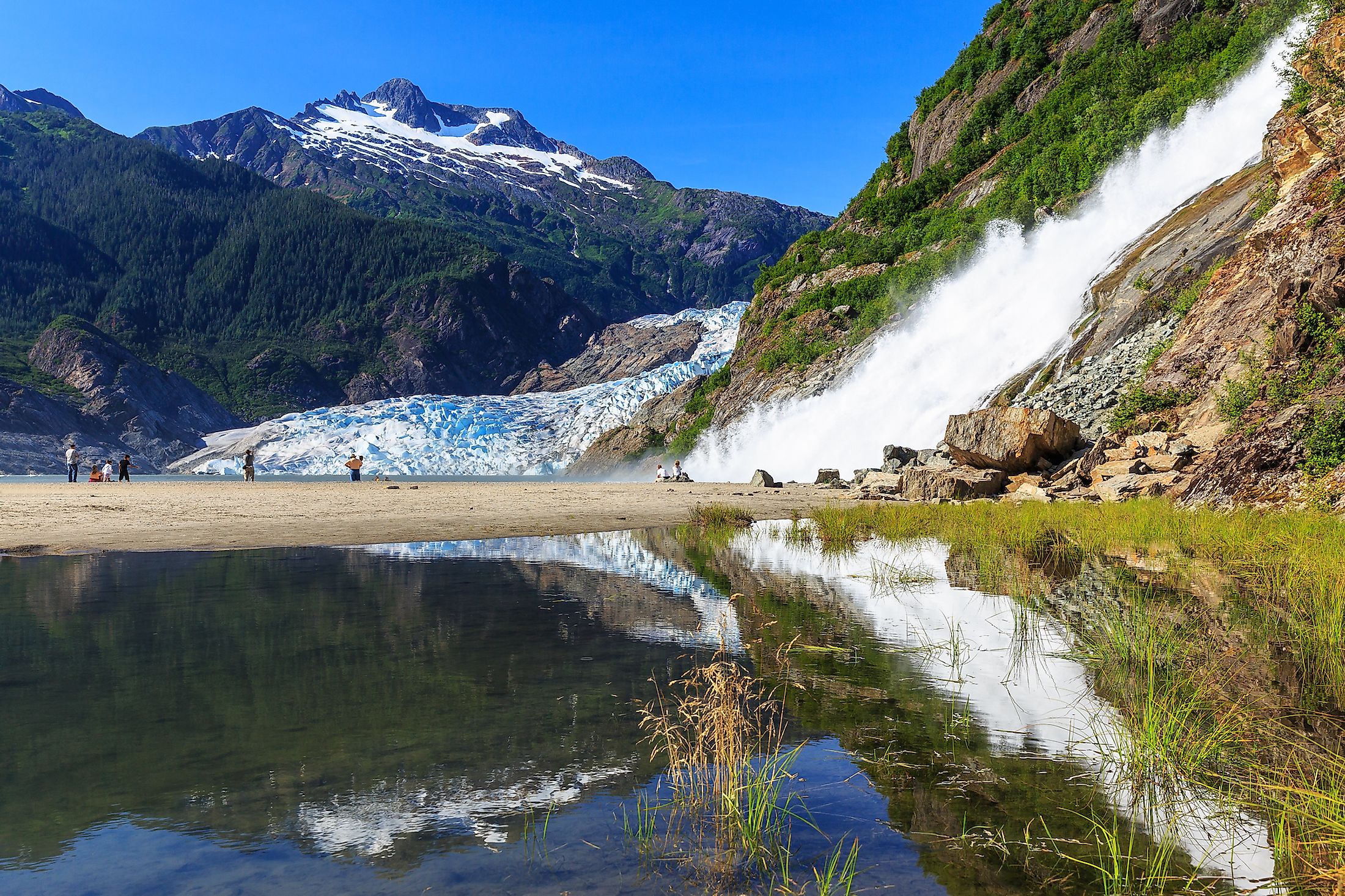 Tourists visiting the Mendenhall Glacier and Nugget Falls in Alaska.