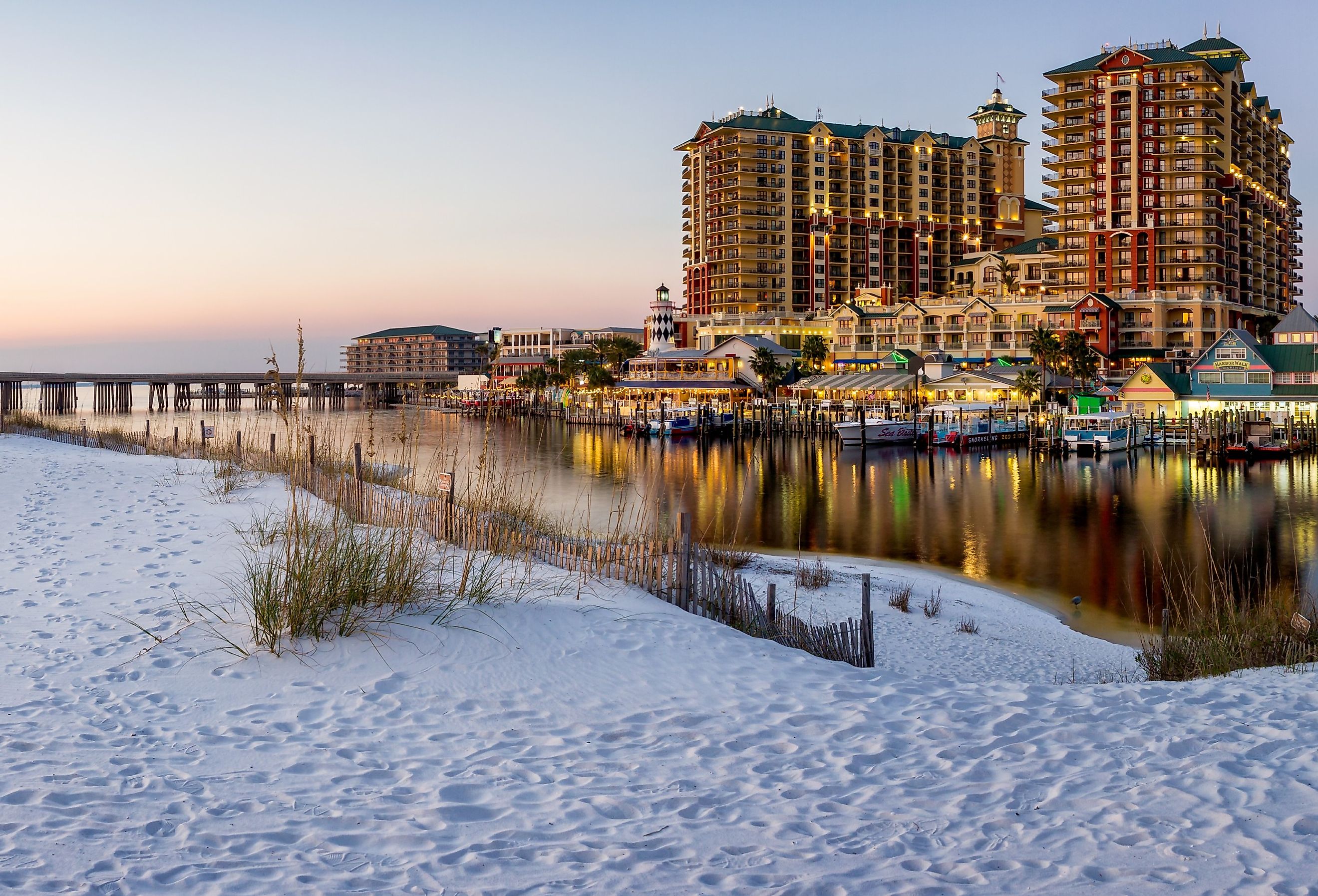 Panoramic sunset photo of HarborWalk Village in Destin, FL. Image credit speedrealm via Adobe Stock.