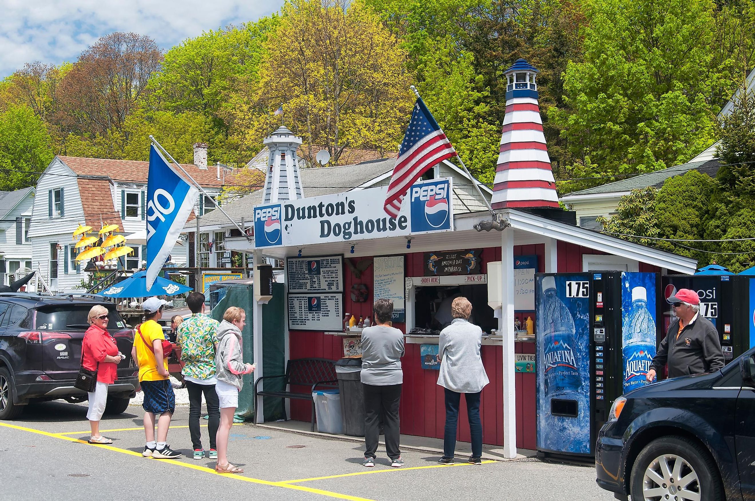 People lined up outside of Dunton's Doghouse hot dog stand in the town of Boothbay Harbor Maine.