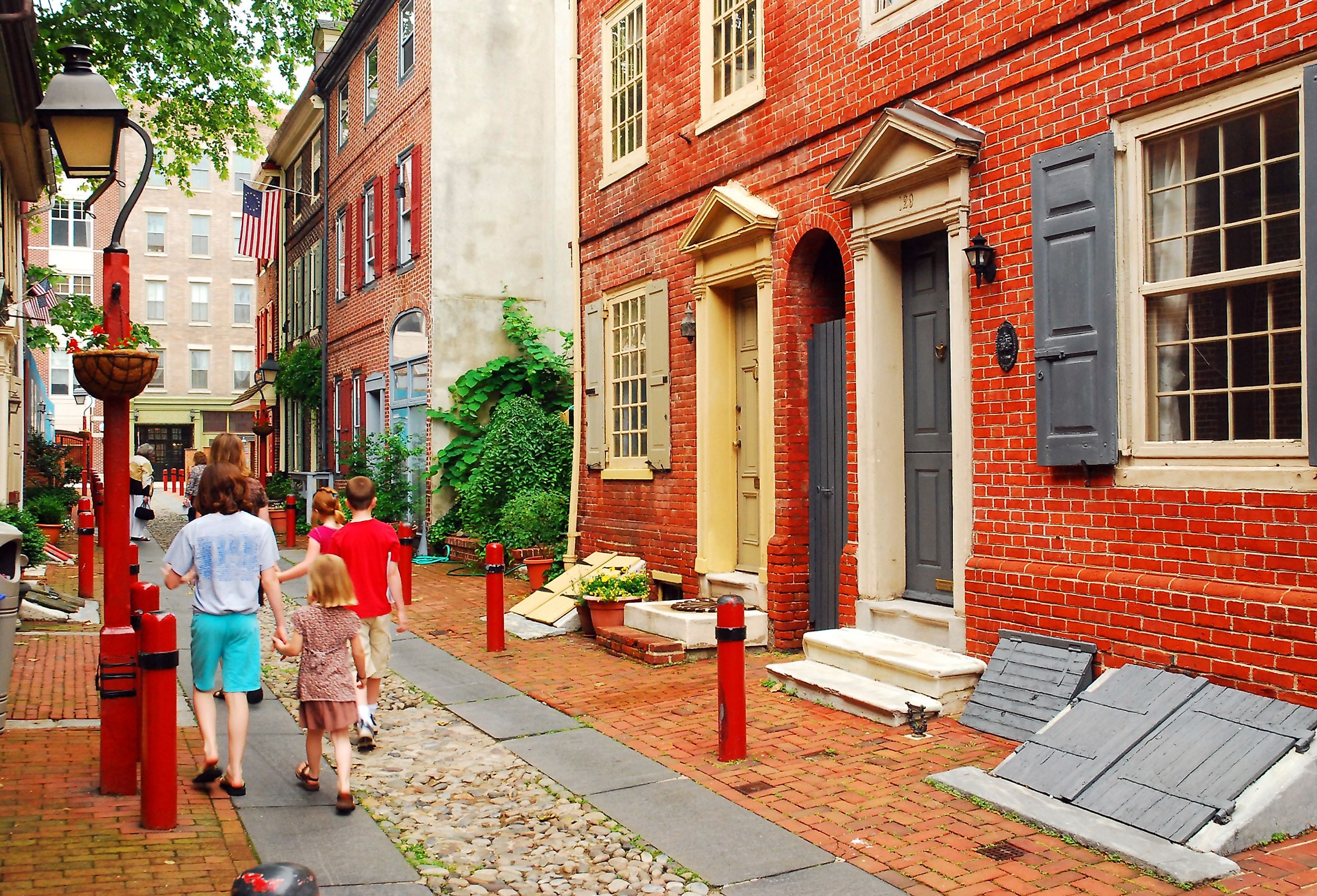 A family strolls down Elfreth's Alley, Philadelphia, the oldest street in continuous use in the United States.