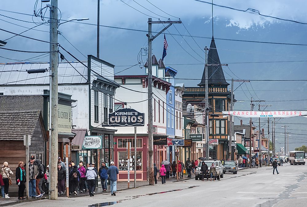 People walk down the street in Skagway, Alaska. Editorial credit: CREATISTA / Shutterstock.com.