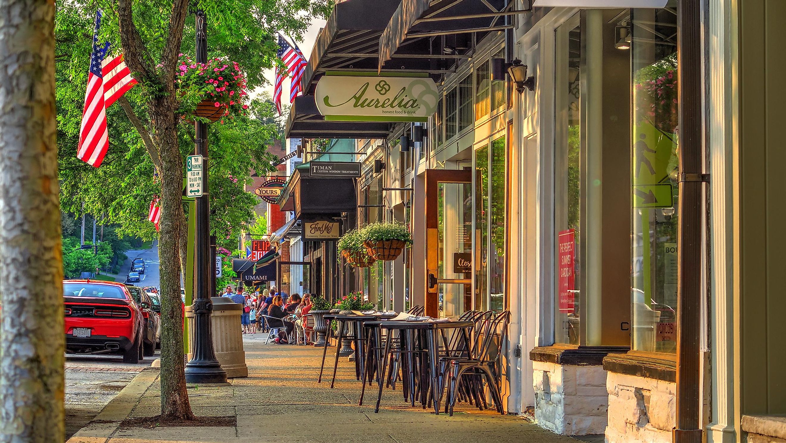 Chagrin Falls, Ohio / USA - May 31, 2019: Summer Late Afternoon Warm Sunny Scene of Sidewalk and Shops on Main Street in the Business District of Historical Downtown Chagrin Falls, Ohio. Editorial Credit: Lynne Neuman via Shutterstock.