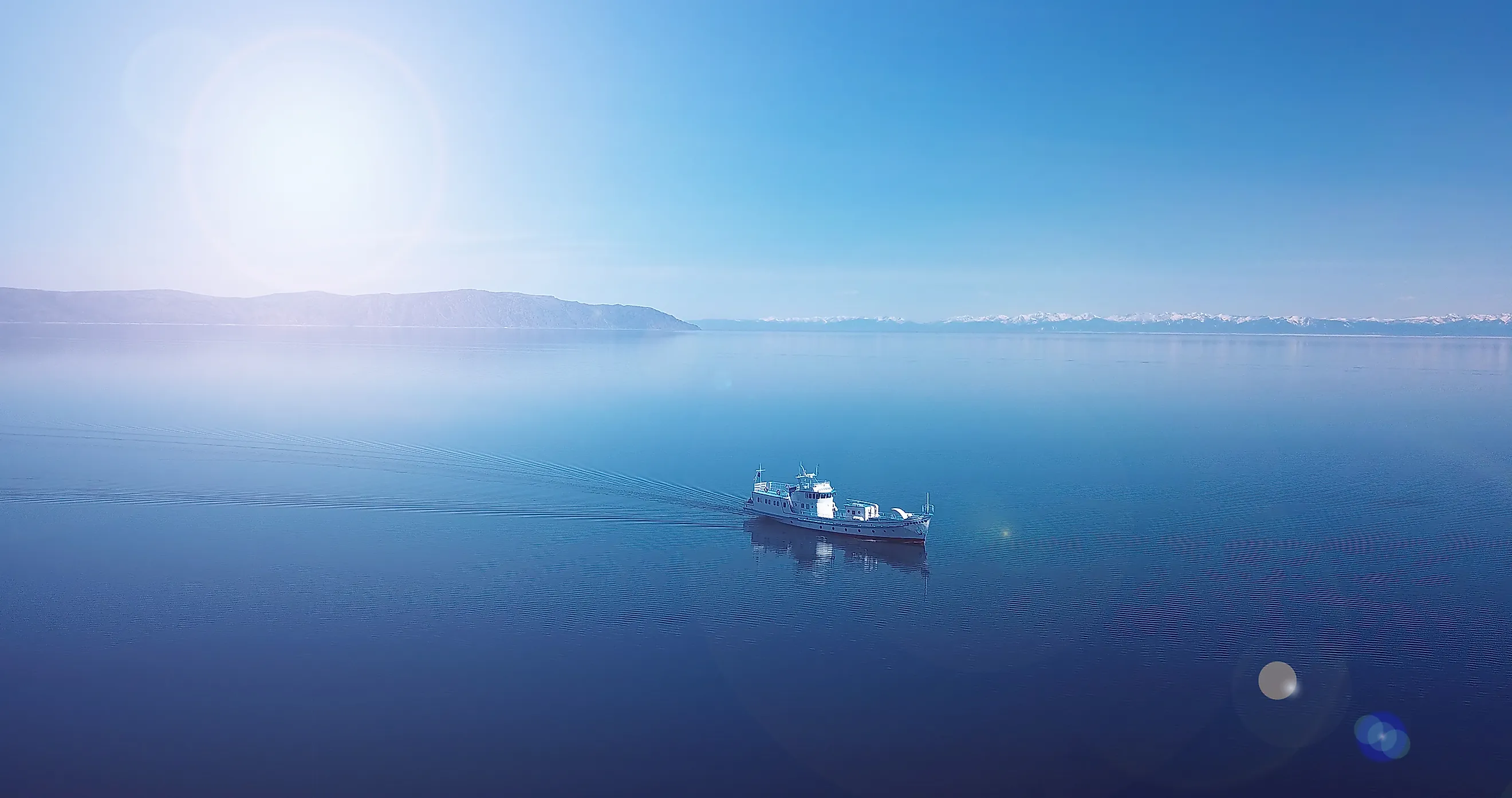 Aerial view of a ship floating in the water. Lake Baikal. Blue water.