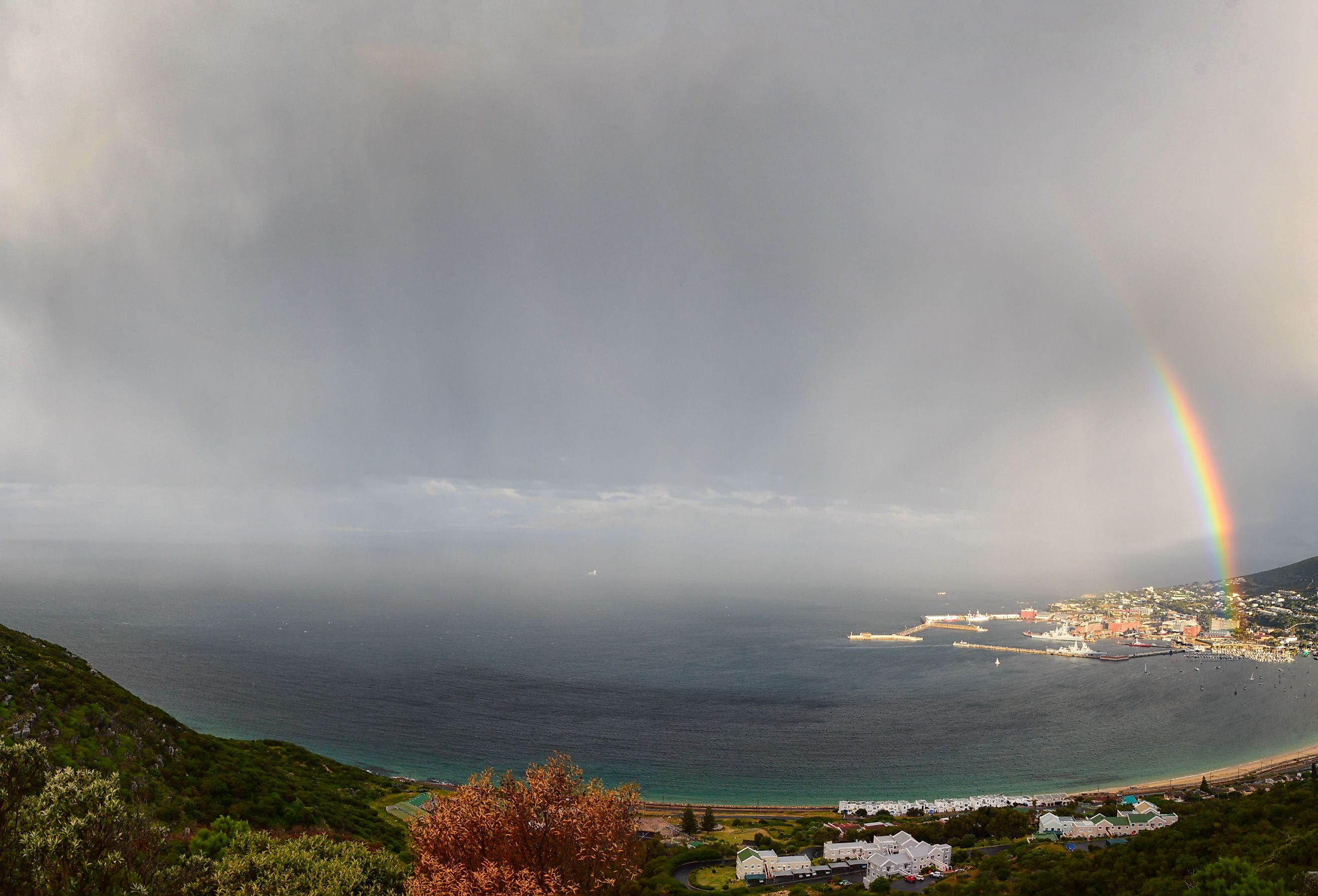 A magnificent double rainbow over the village of Simon's Town, on False Bay, South Africa. Image credit Cathy Withers-Clarke via Shutterstock. 