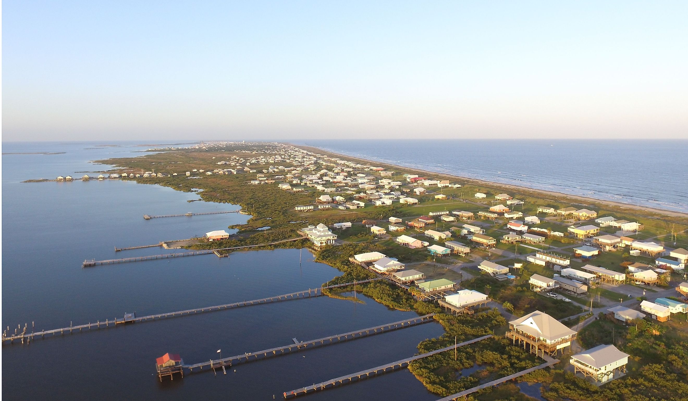 Stilt houses with long docks in the low-lying town of Grand Isle, Louisiana.