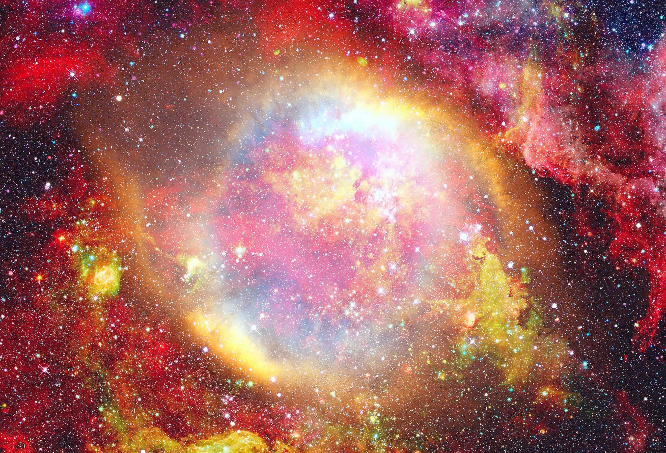 Colorful supernova explosion with glowing nebula in the background.
