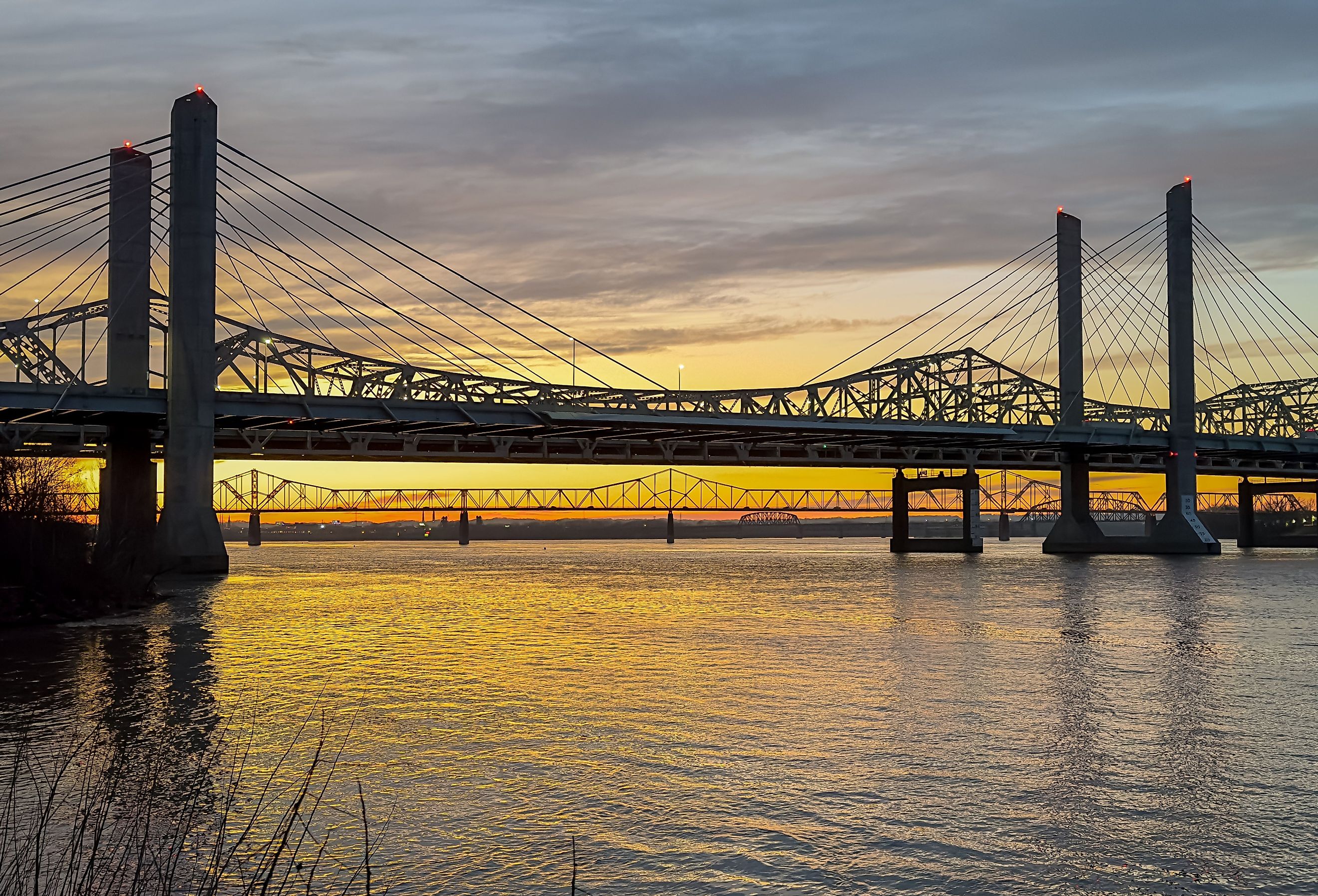 John F. Kennedy Bridge and Abraham Lincoln Bridge crossing the Ohio River between Louisville, Kentucky and Jeffersonville, Indiana at sunset. Image credit Carrie A Hanrahan via Shutterstock.