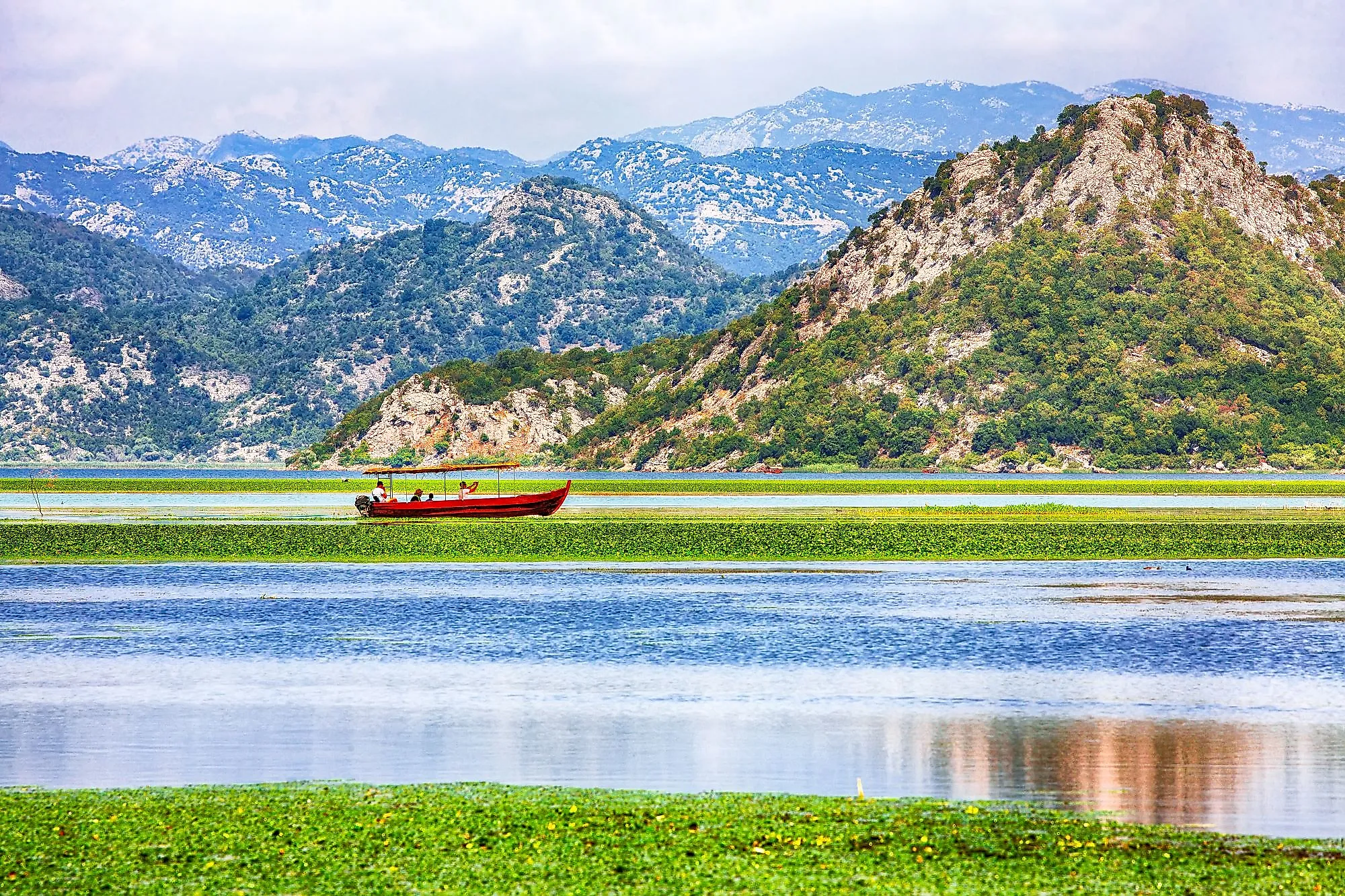 Awesome view of Skadar Lake surrounded by green mountain peaks in Skadar Lake National Park, Montenegro.