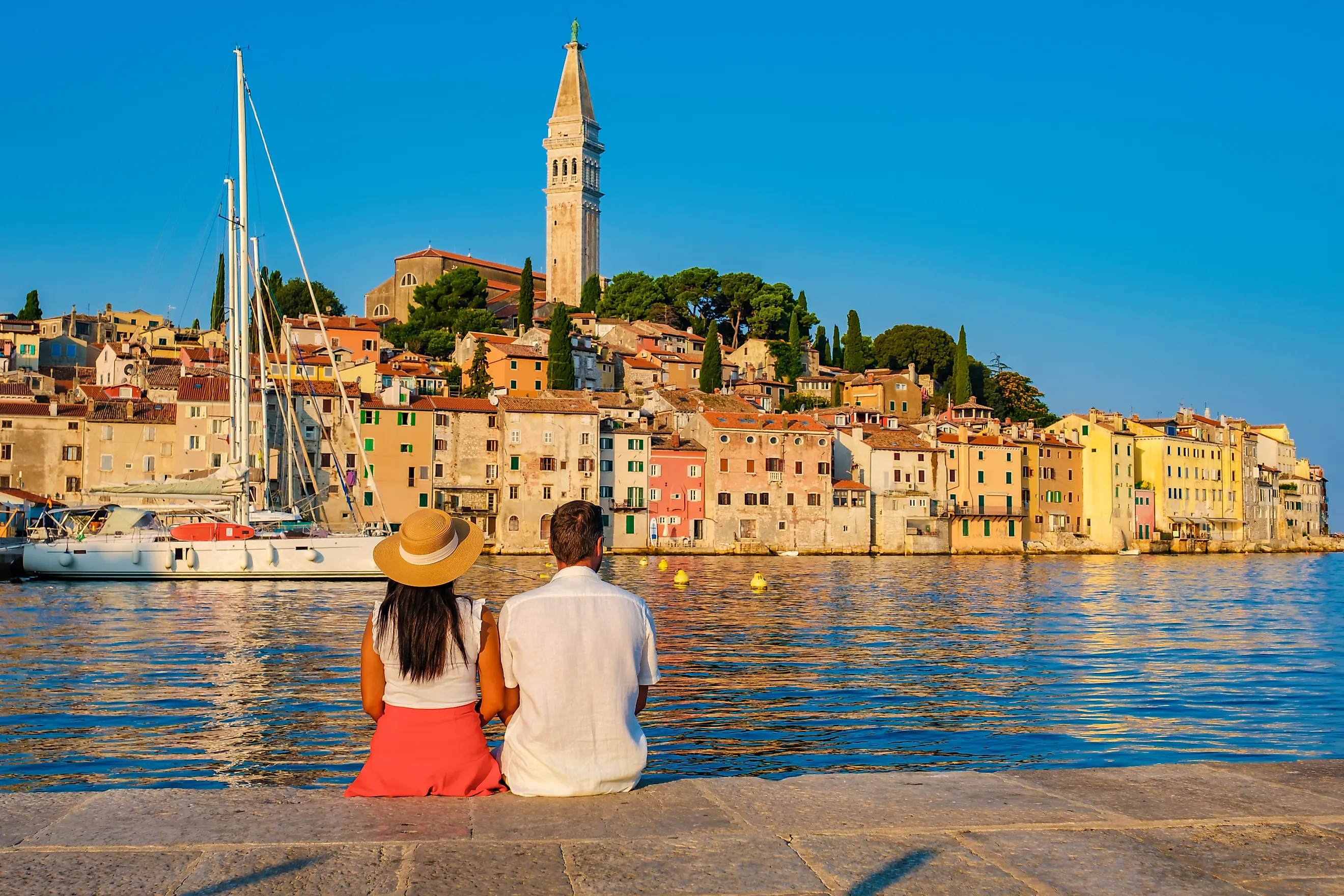 A couple relaxes by the water in the friendly town of Rovinj, Croatia, via Shutterstock user fokke barrssen.
