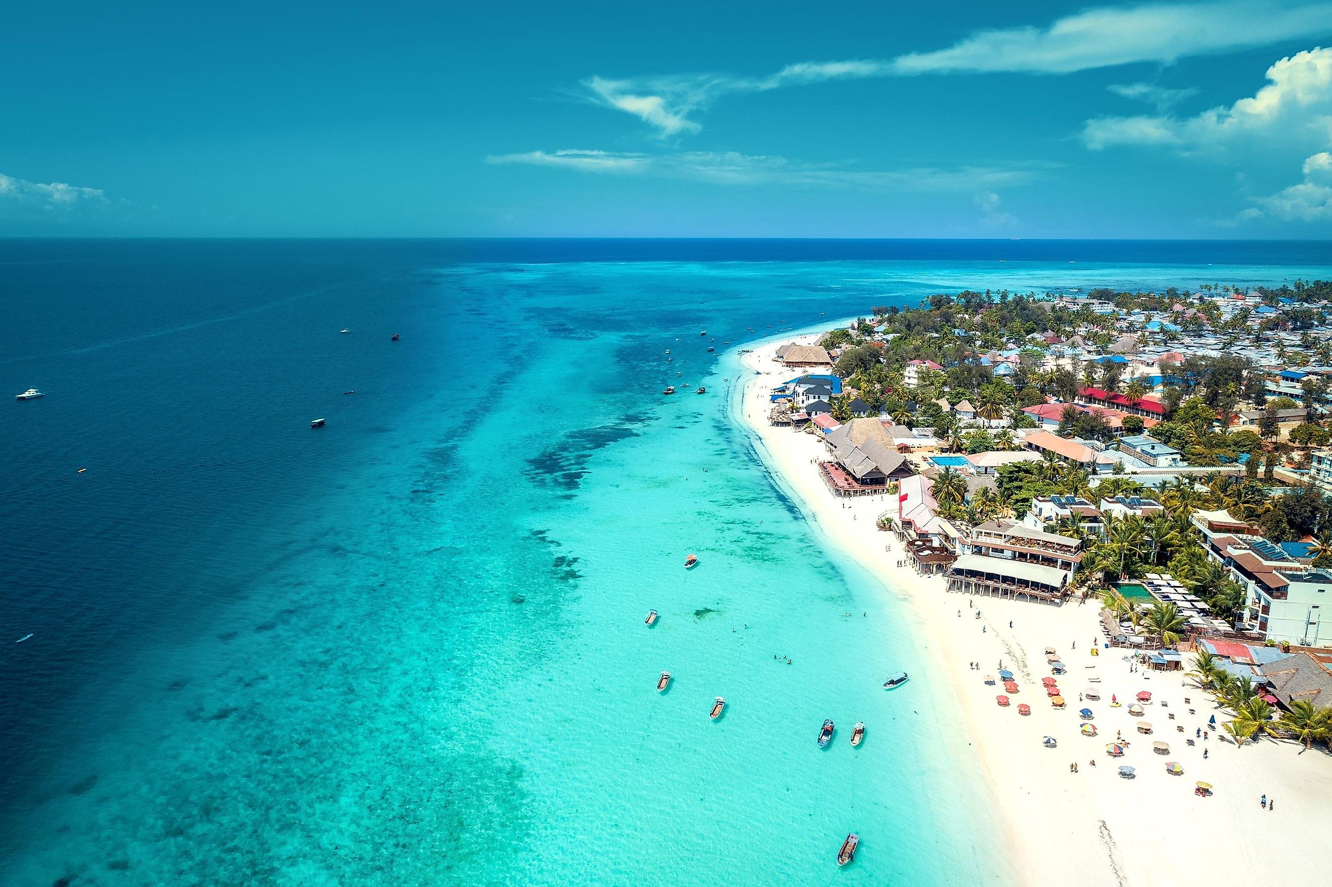 Aerial view of Nungwi beach in Zanzibar, Tanzania, featuring a luxury resort and turquoise ocean water. 