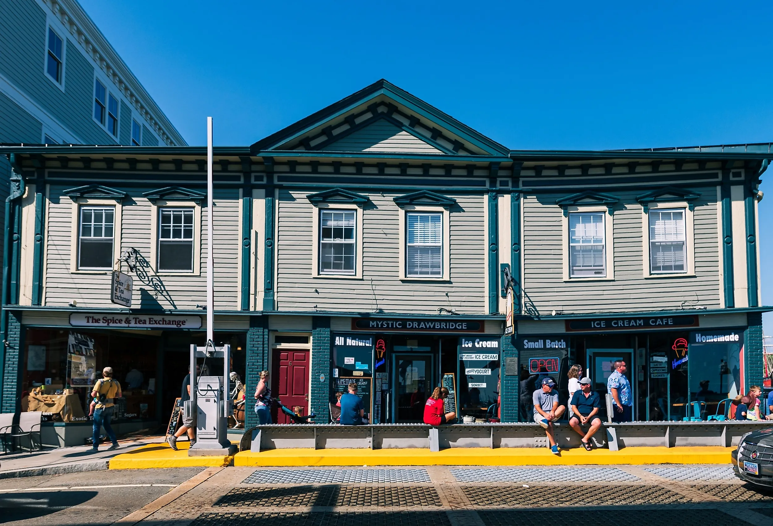 View of busy street with shoppers and tourists in Mystic, Connecticut. Image credit: Will Zinn via Shutterstock.