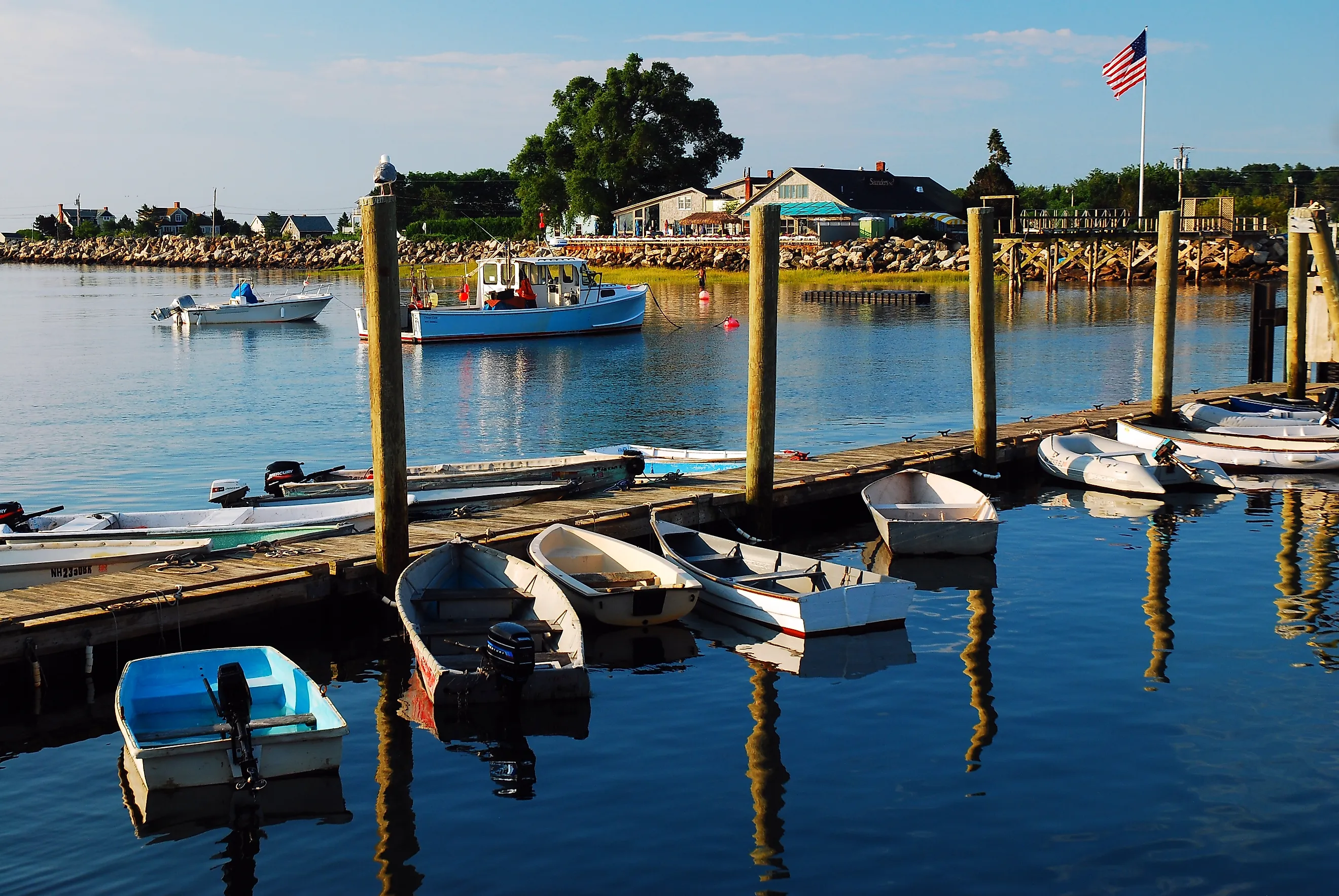 A dock in calm, reflective water off the coast of Rye, New Hampshire.