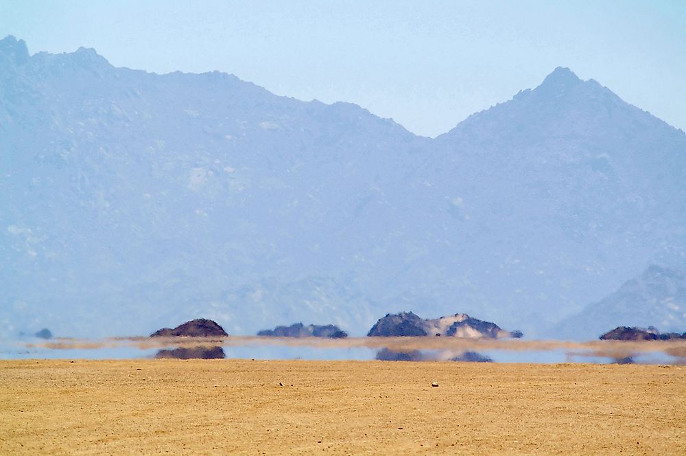 Mirages appear in arid environments like deserts.