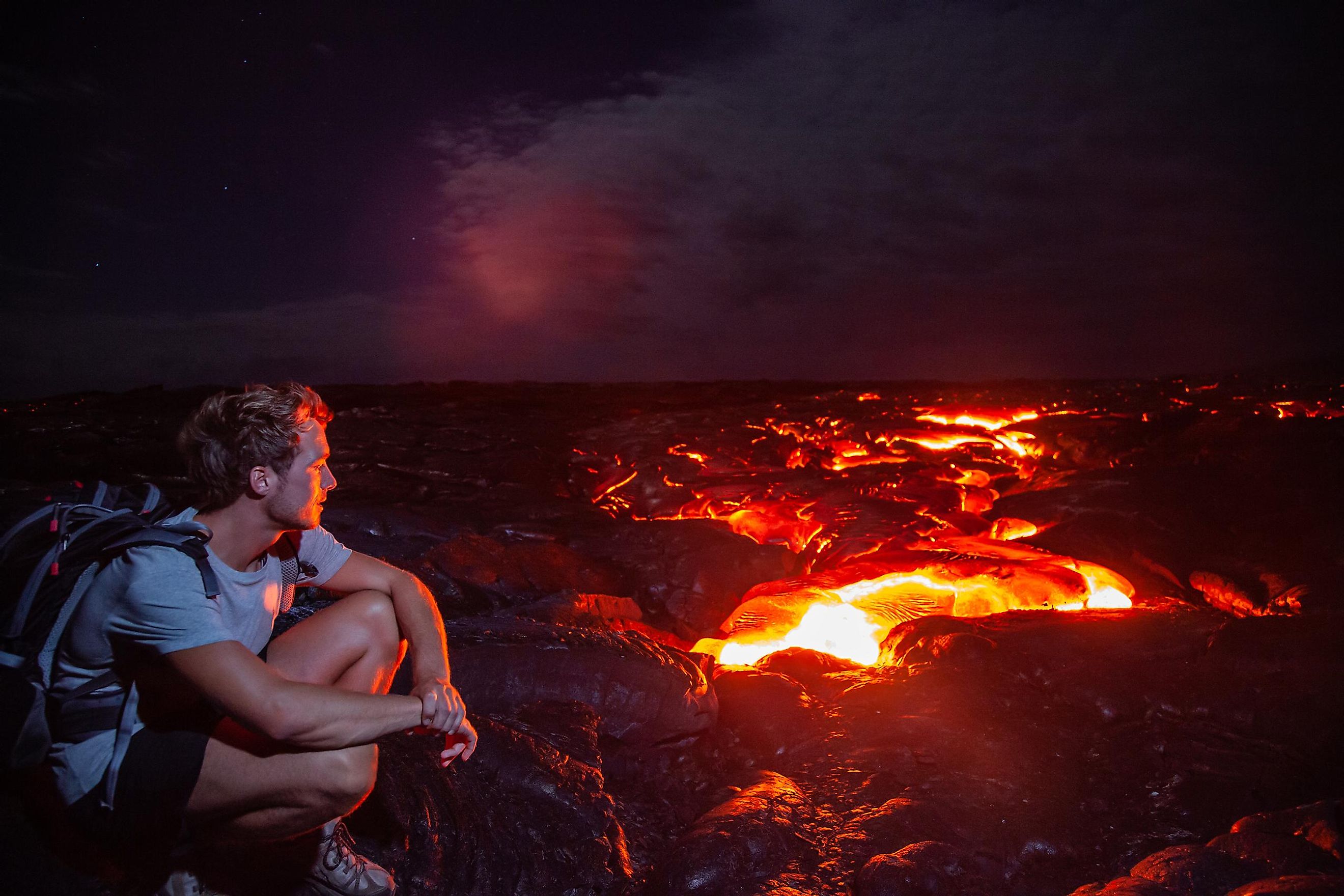 Tourist admiring the spectacular view of a volcano at the Hawaii Volcanoes National Park.
