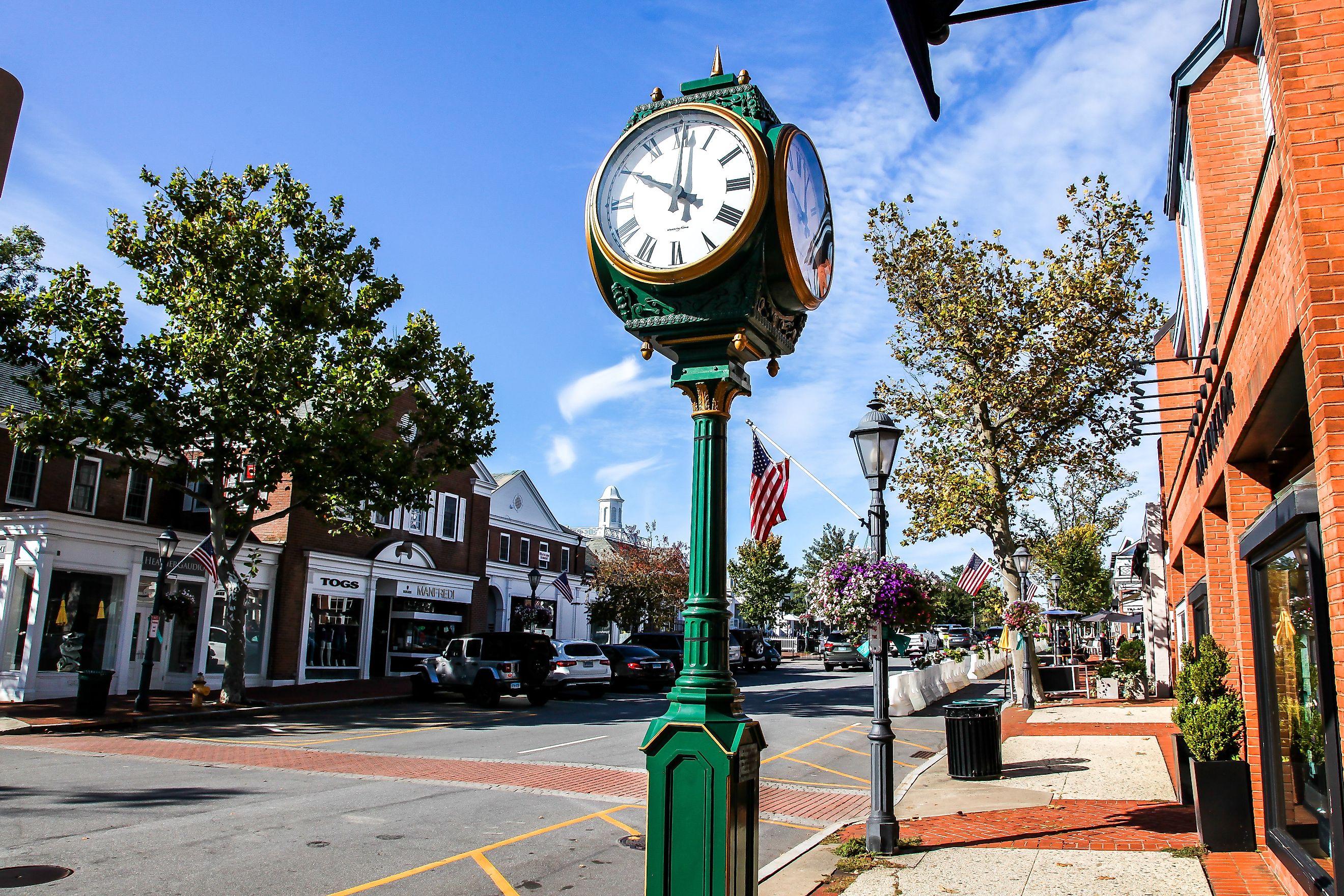 Downtown in nice day with clock, store fronts, restaurant and blue sky on Elm Street