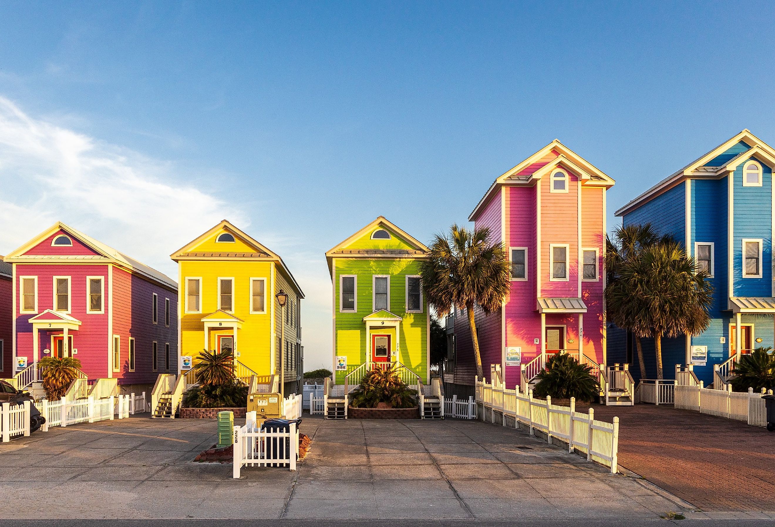 A row of colorful beachfront homes on a beautiful afternoon on St George Island, Florida. Image credit H.J. Herrera via Shutterstock