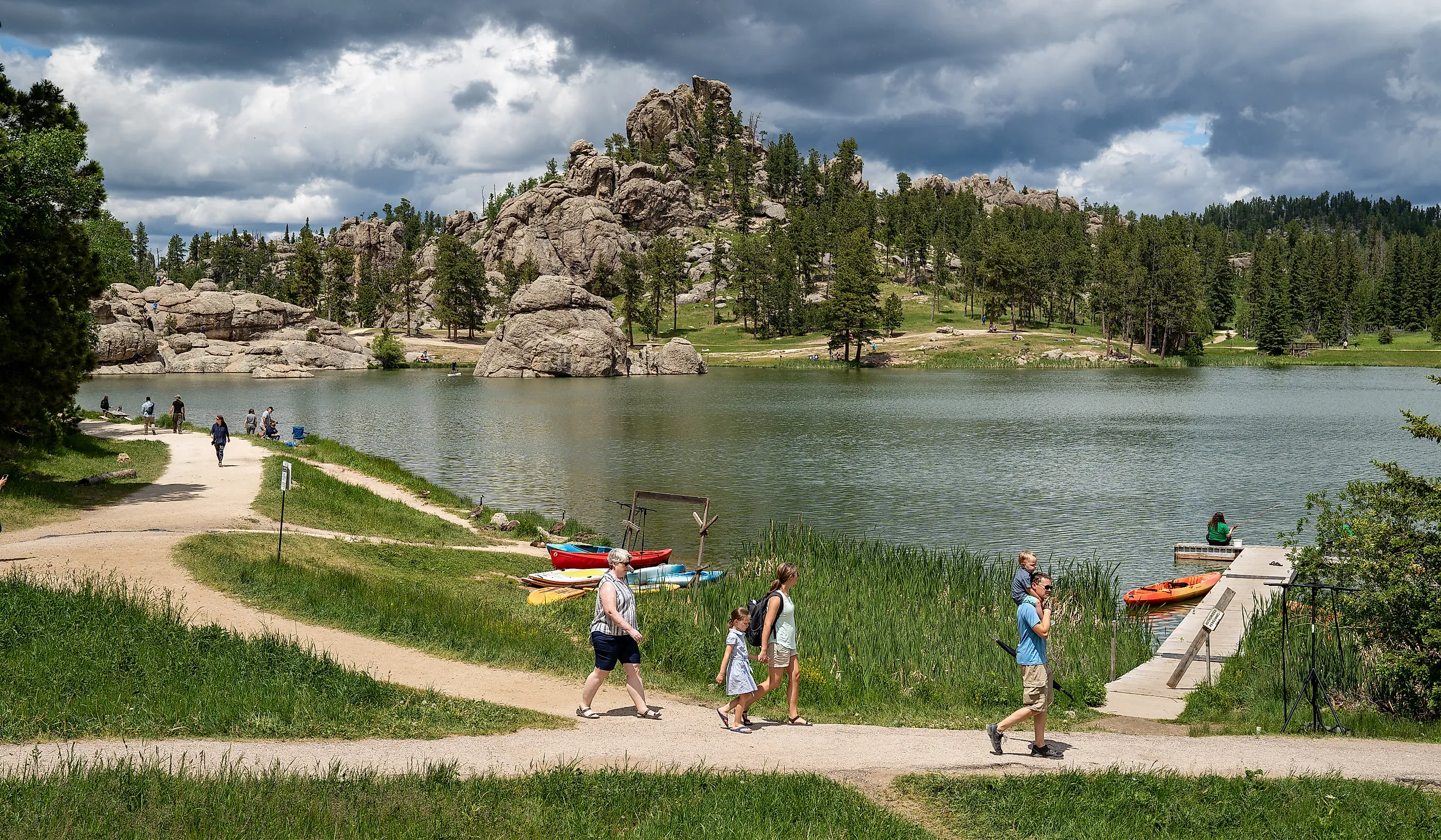 Families enjoy a summer day on Sylvan Lake in Custer State Park, South Dakota. Image credit: Melissamn / Shutterstock.com.