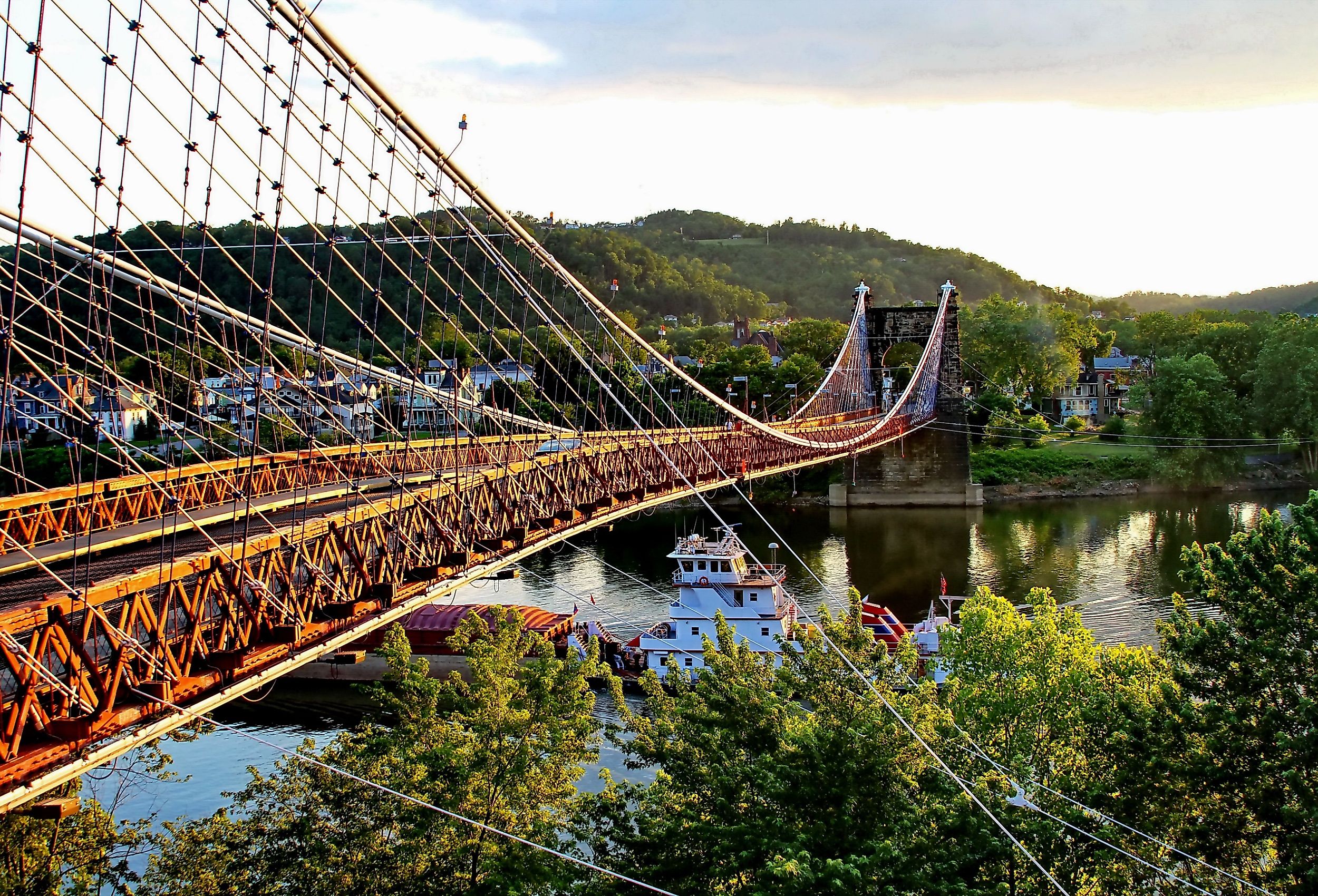 Barge going under the Famous Suspension Bridge at Wheeling, West Virginia.