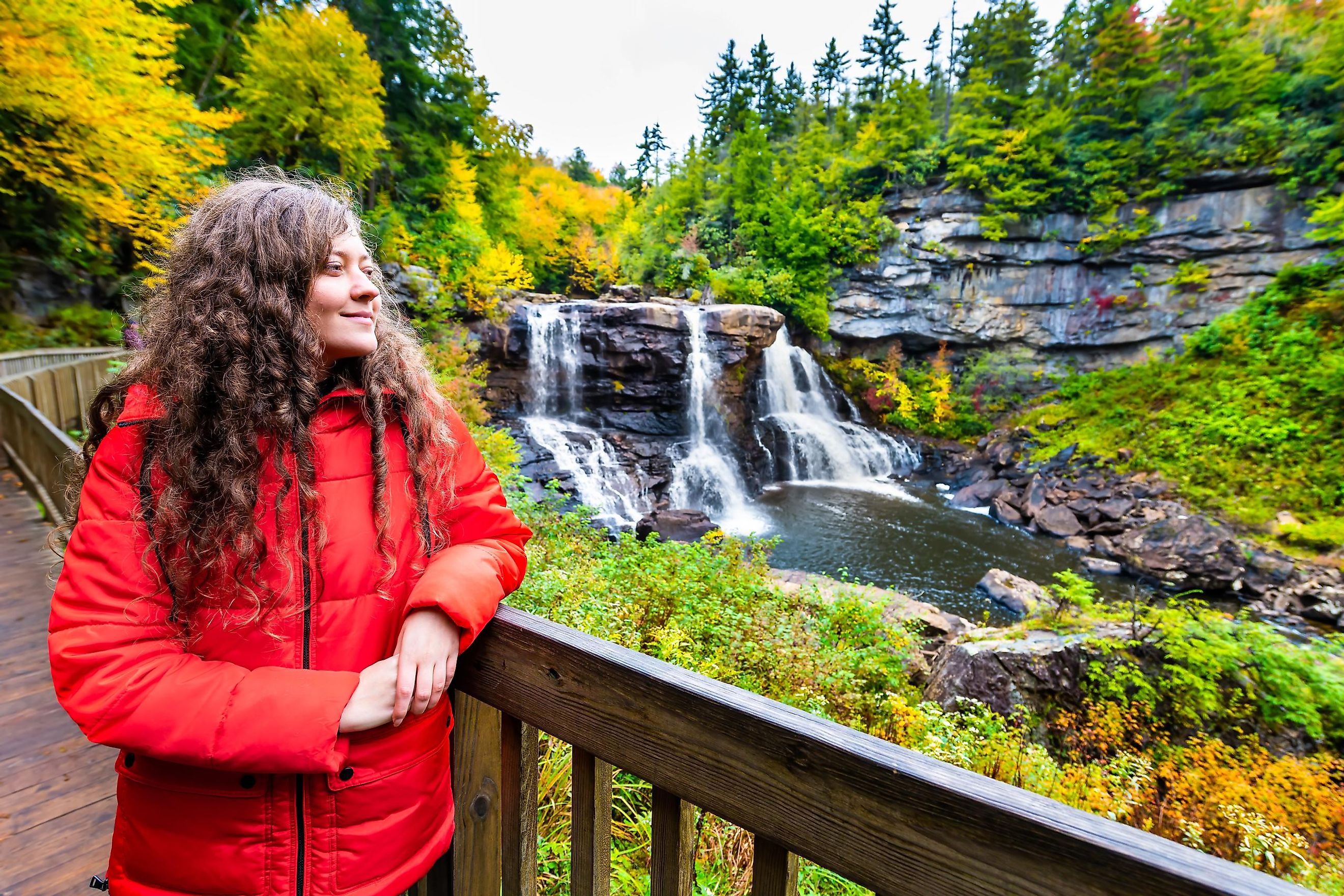 Young Woman on Boardwalk Overlook at Blackwater Falls State Park, West Virginia, USA, During Autumn.