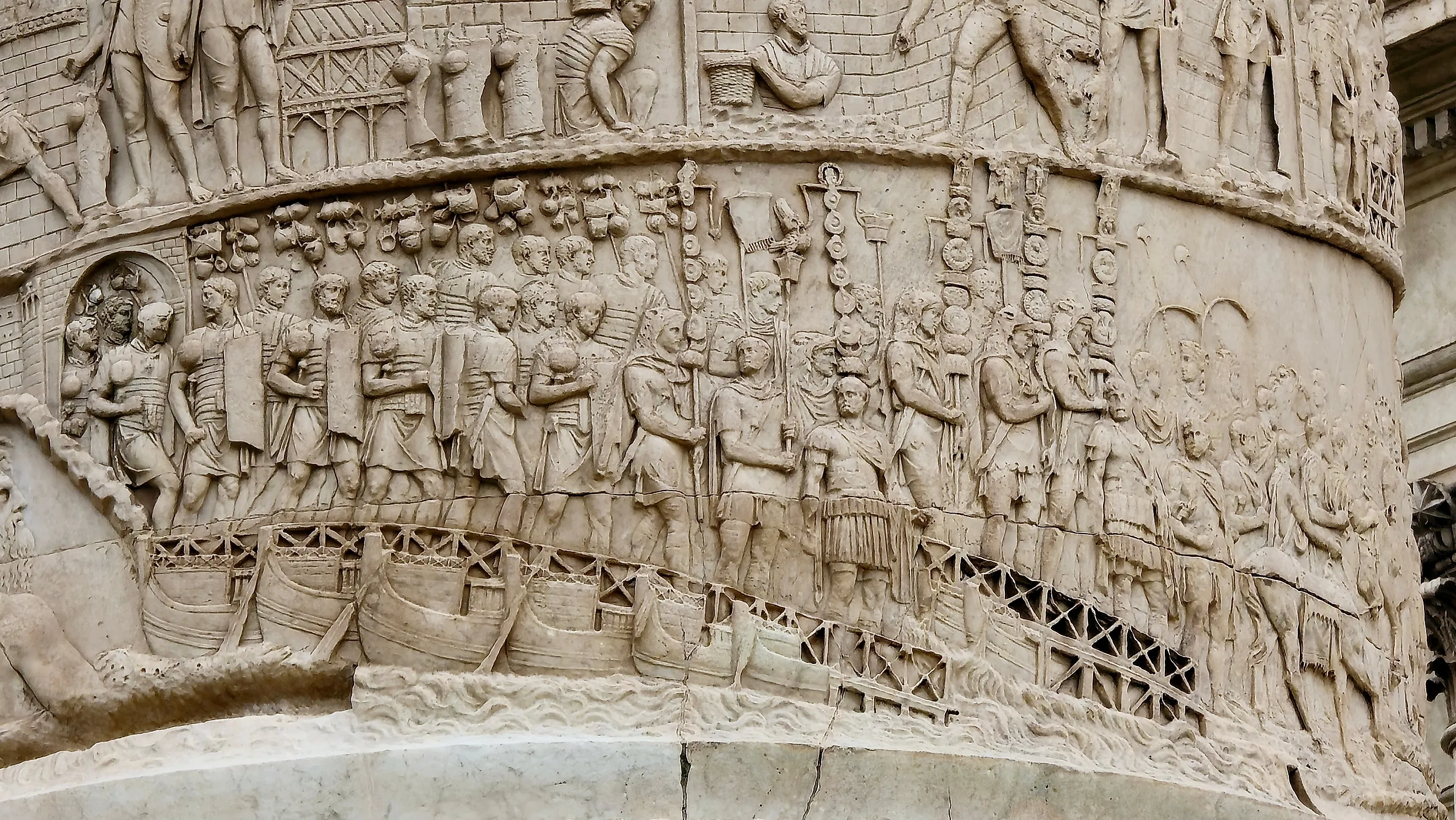 Detailed stone relief on Trajan's Column shows Roman soldiers during a military campaign. Image credit: History Skills / Shutterstock.com.