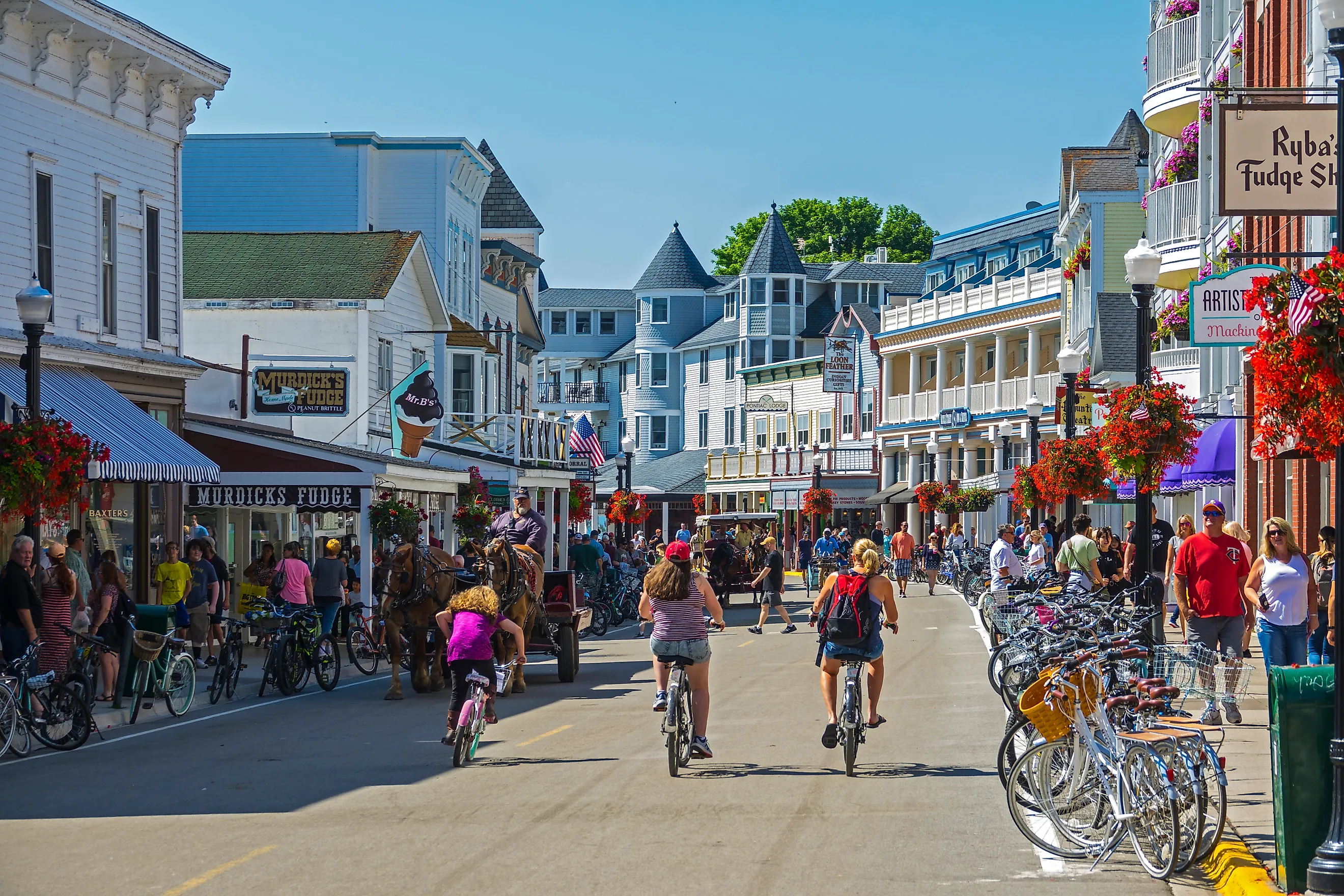 People at the downtown area of Mackinac Island, Michigan, to enjoy its many attractions.