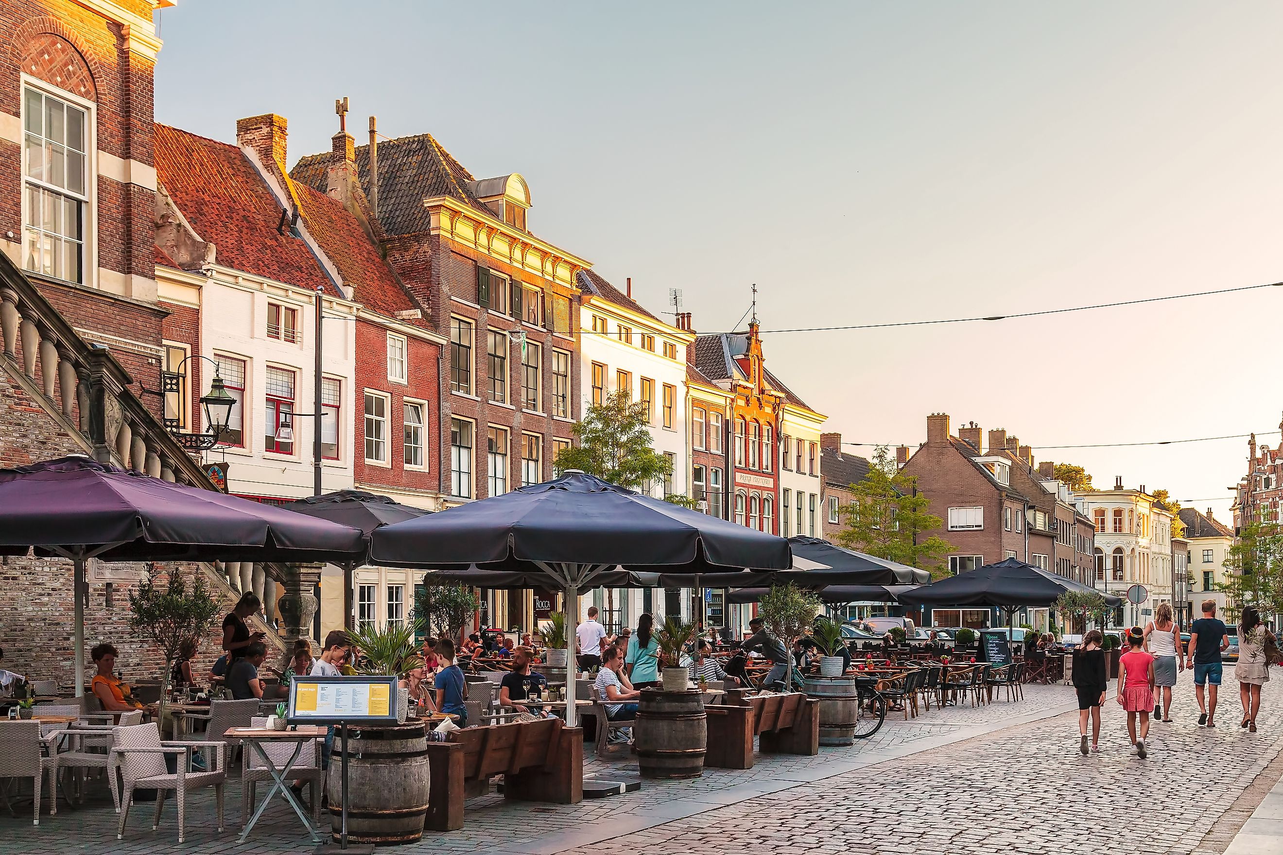 Restaurants with people on the Houtmarkt central square in the Dutch city of Zutphen, The Netherlands. Image credit: Martin Bergsma / Shutterstock.com.