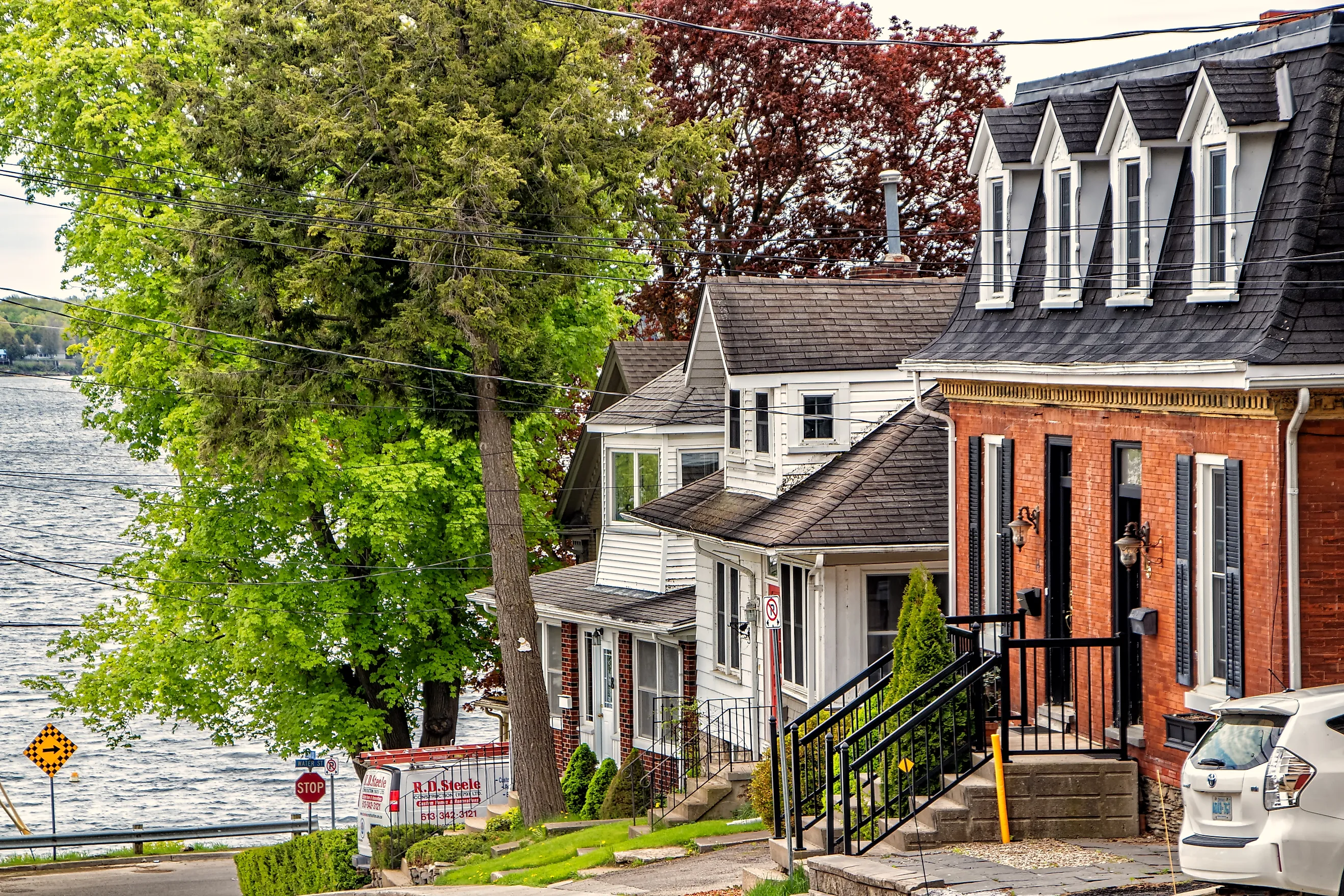 Editorial Photo Credit: JohnInNorthYork via Shutterstock. Brockville, Ontario - May 13, 2024: Street Leading Down to the River