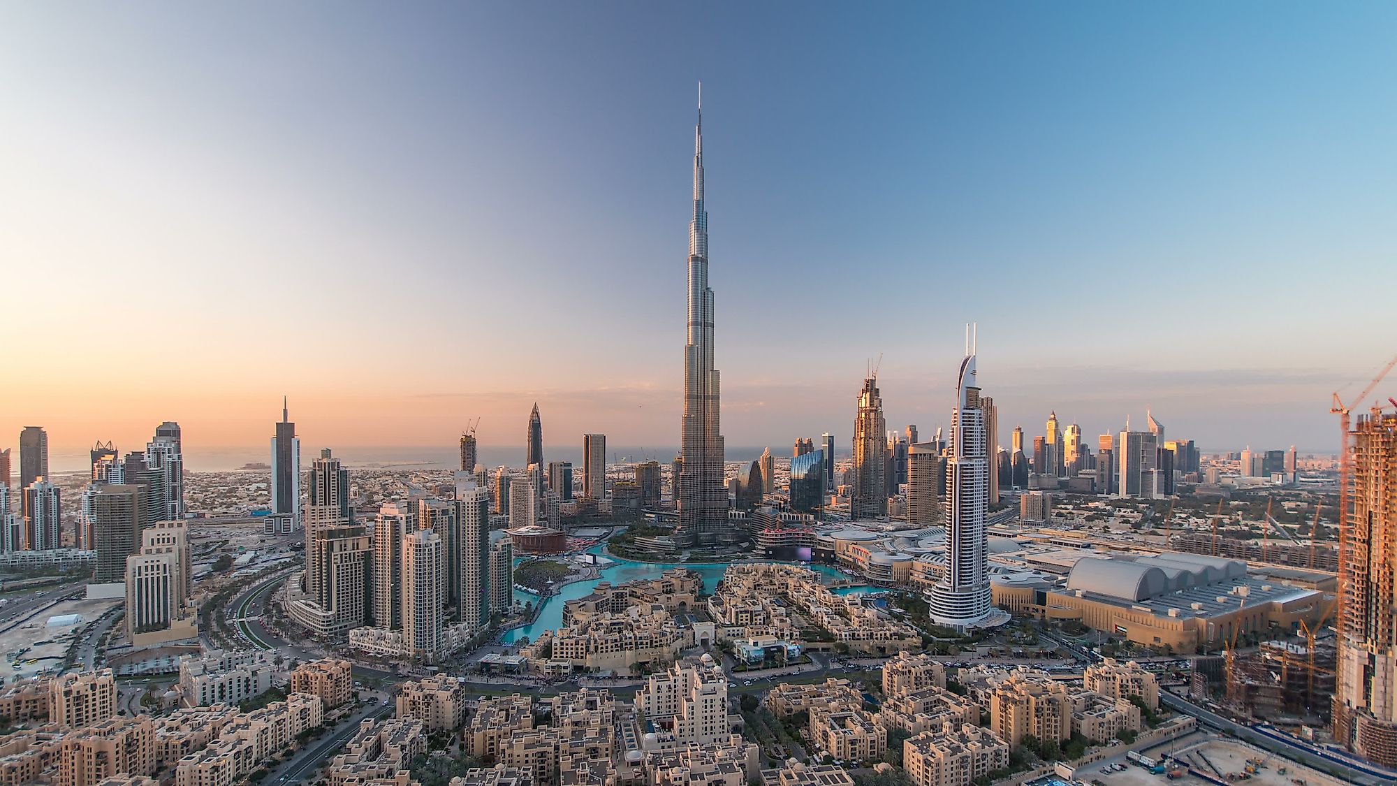 Dubai United Arab Emirates  2 November 2018 Scenic Evening View Of  Under Construction Skyscrapers And Al Amal Street Of Business Bay The Burj  Khalifa Tower Is Visible On Blue Sky Background