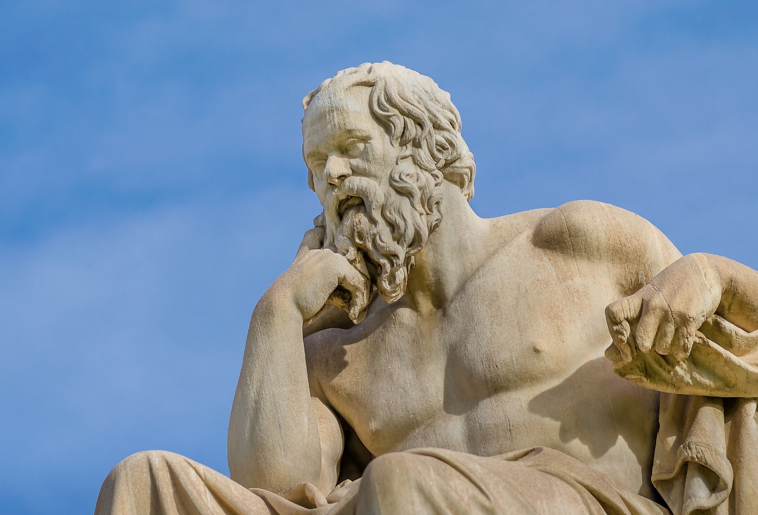 Close-up of Greece philosopher Socrates as he reflects on the meaning of life on the background of blue sky.