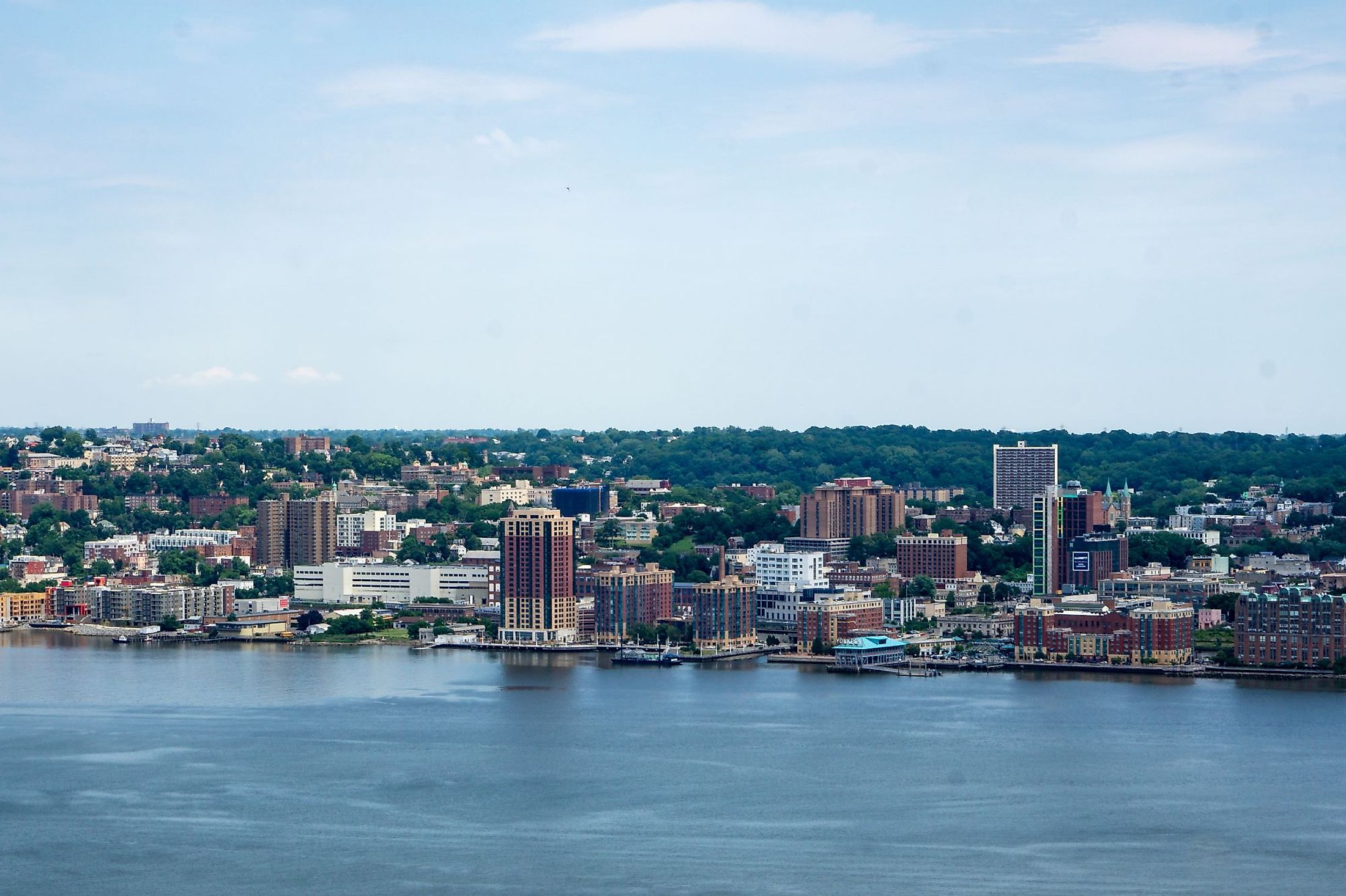 Wide view of the skyline of Yonkers with the Hudson River in the foreground. Editorial credit: Brian Logan Photography / Shutterstock.com