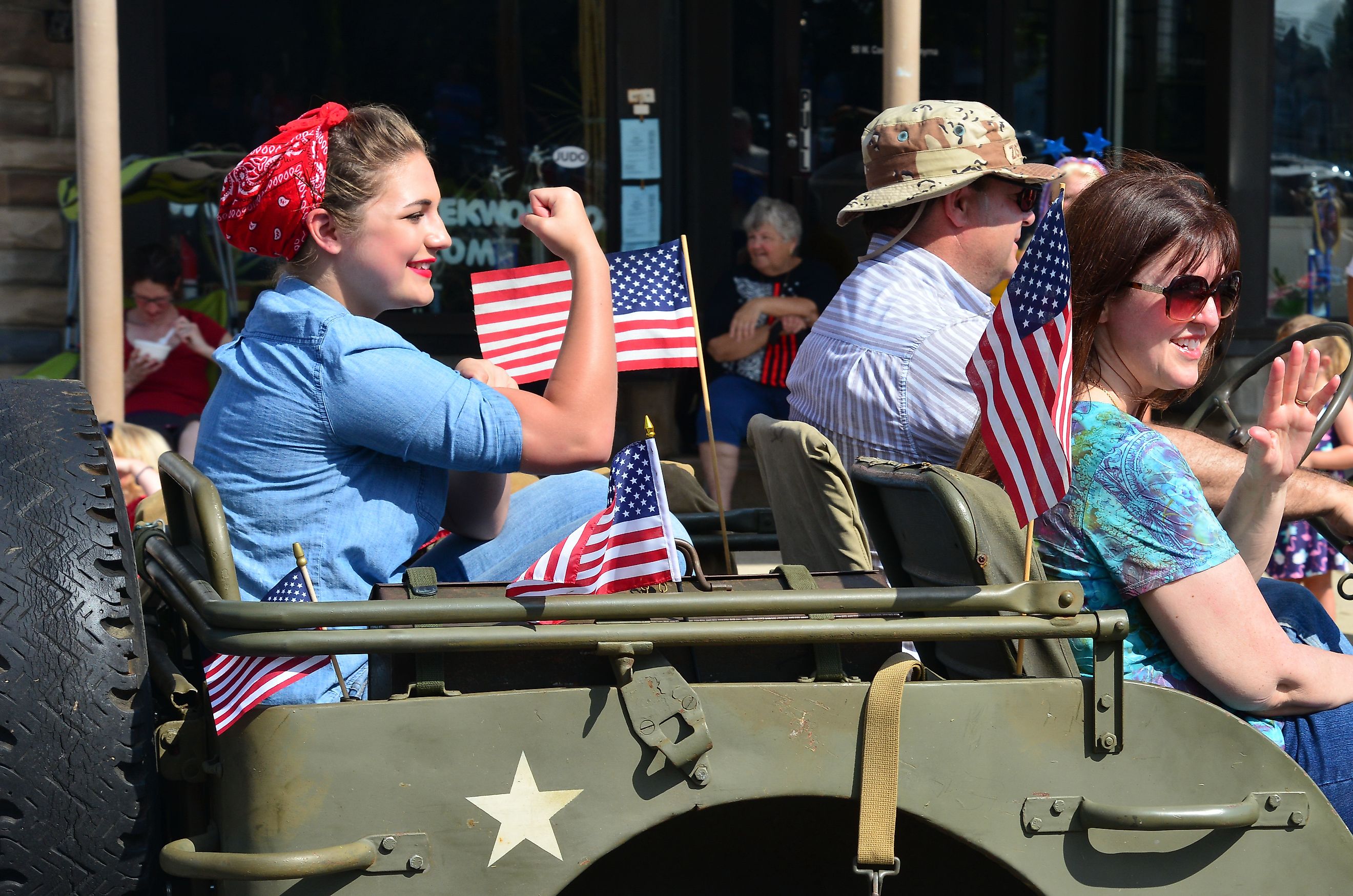 A parade participant recreating the iconic World War II image of Rosie the Riveter during a July 4th parade in Smyrna, Delaware. Editorial credit: The Old Major / Shutterstock.com