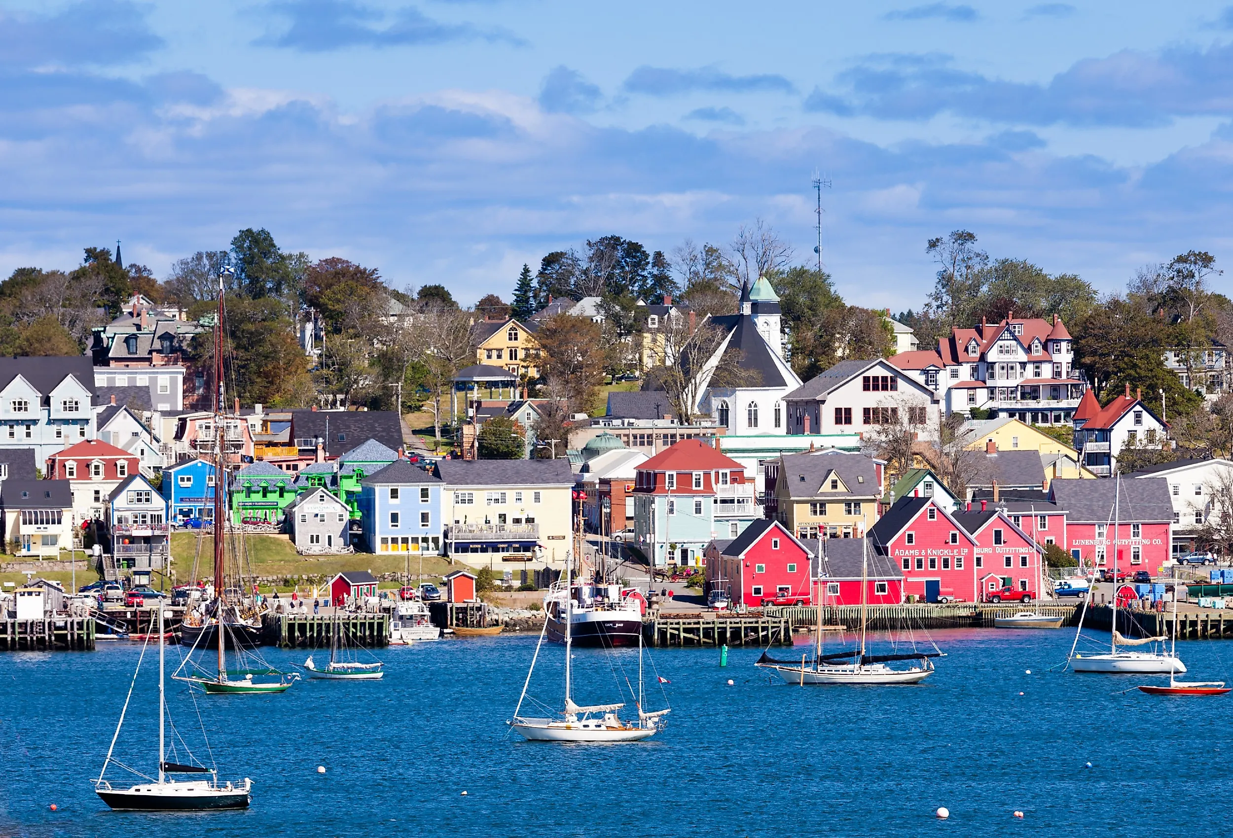 Lunenburg Harbour, Nova Scotia, with colorful red buildings and boats.