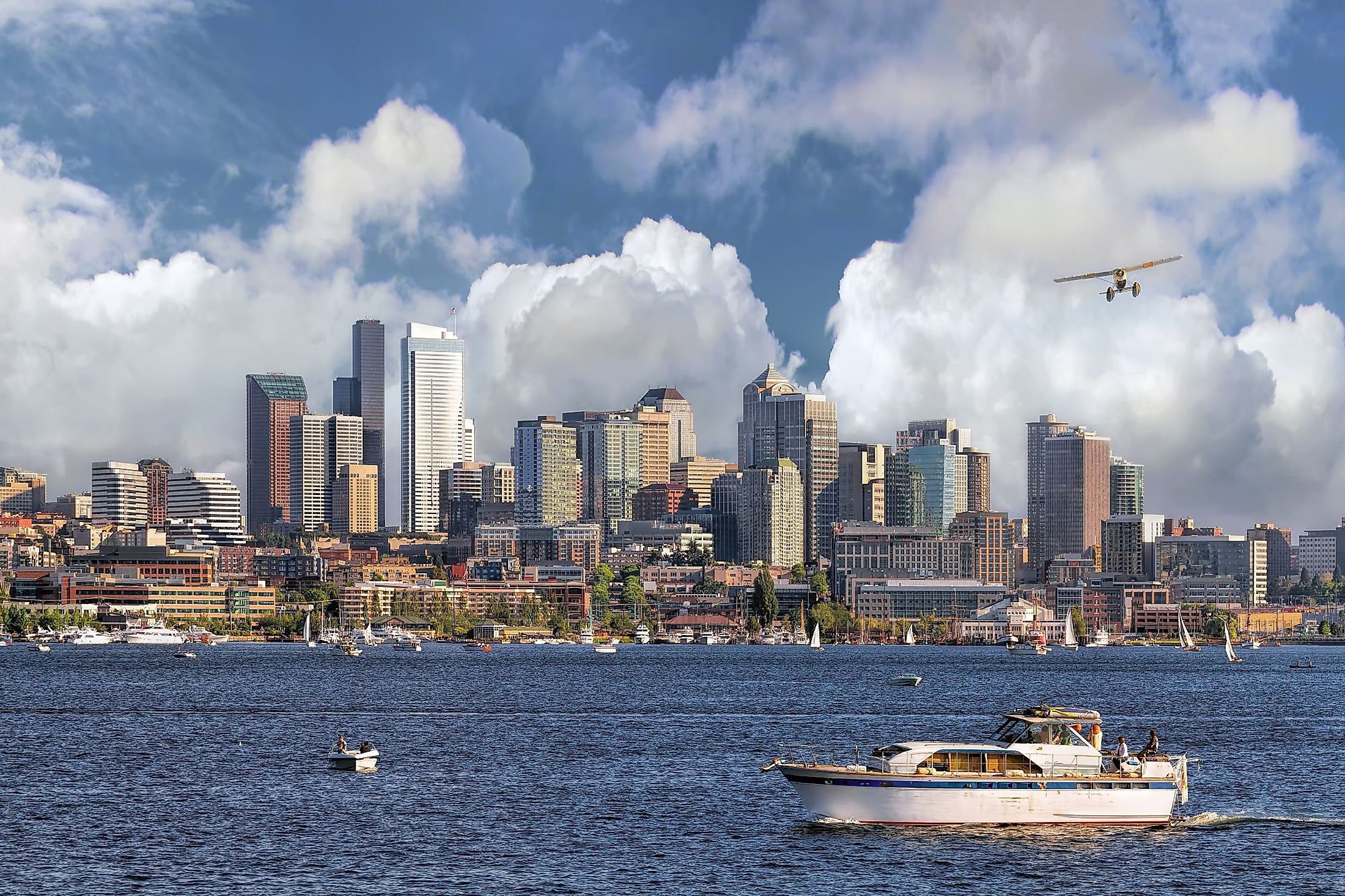 Seattle, Washington, city skyline from Lake Union with white clouds and blue sky. 
