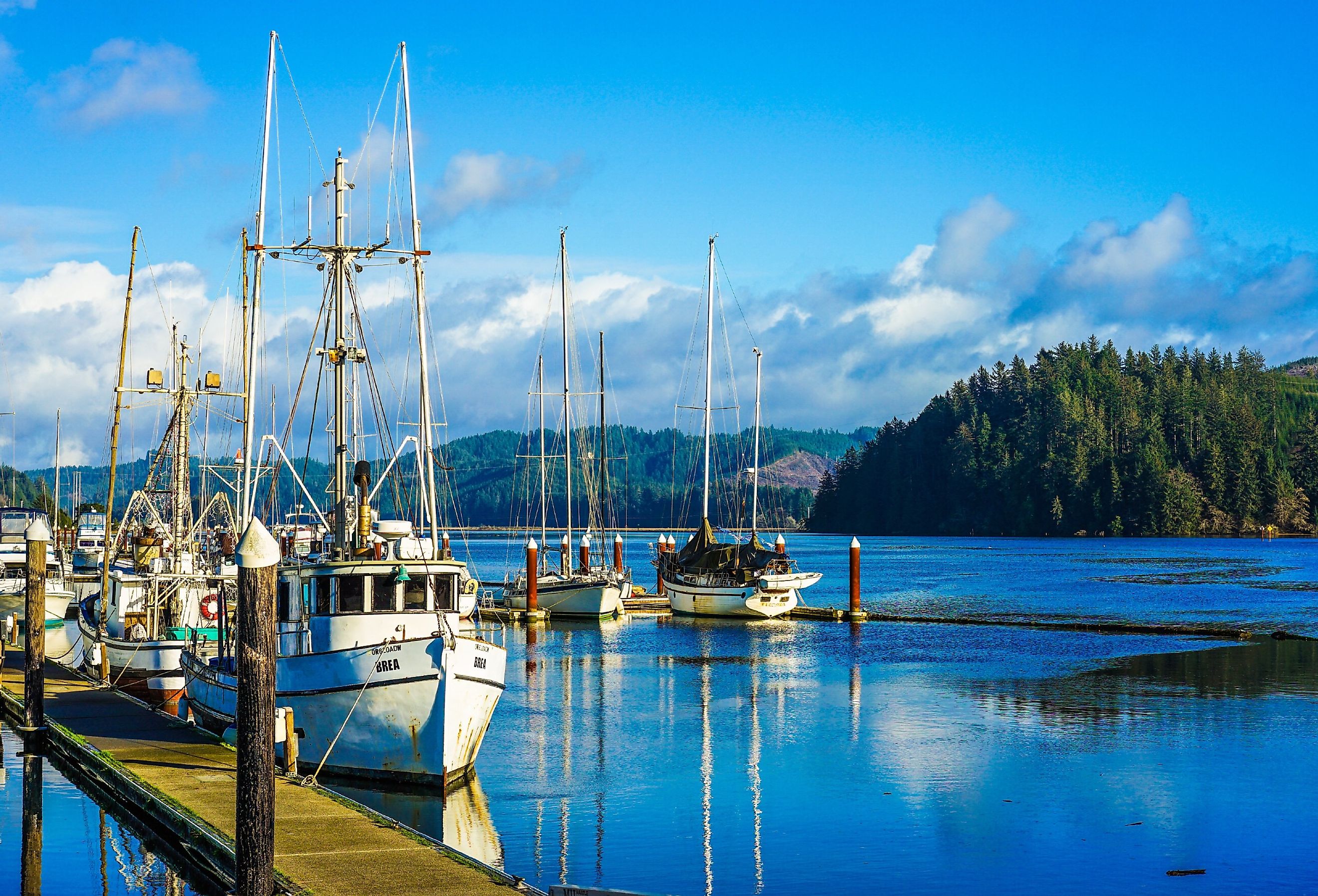 Old small fishing boat in harbor in Florence, Oregon. Image credit NeungPH via Shutterstock