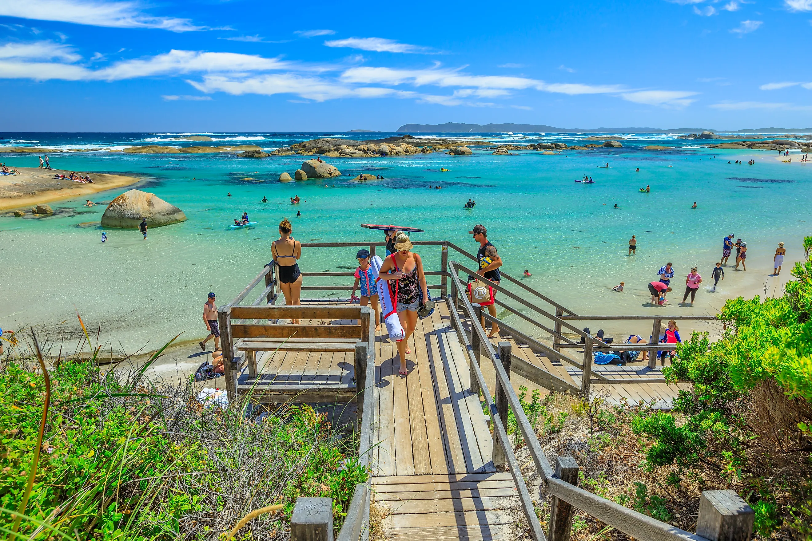 People swimming and canoeing on the sheltered waters of William Bay National Park in Denmark, Western Australia. Image credit: Benny Marty / Shutterstock.com.