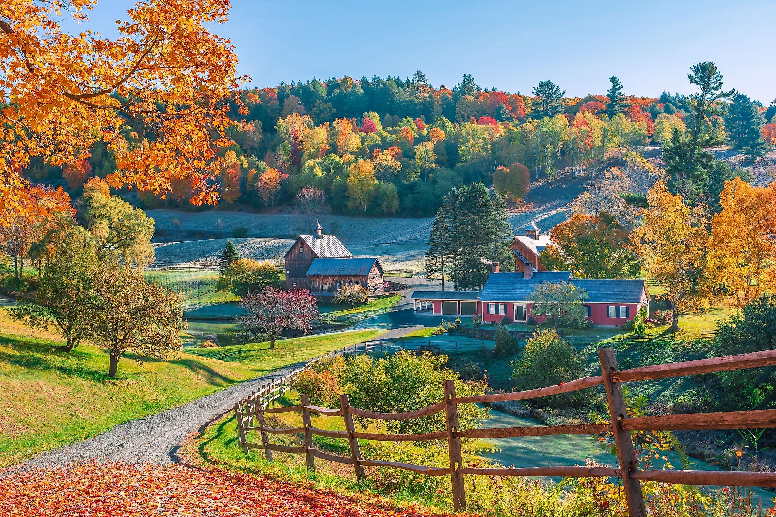 Early autumn foliage scene of houses in the Vermont mountains, Woodstock, Vermont.