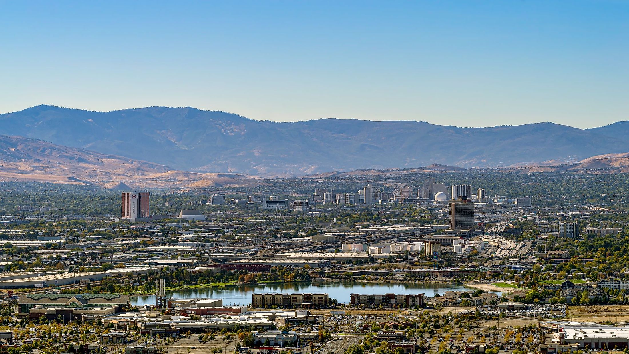 Reno-Sparks cityscape as seen from the East looking West with hotels, casinos and many other businesses and industry on a hazy autumn day. Editorial credit: Gchapel / Shutterstock.com