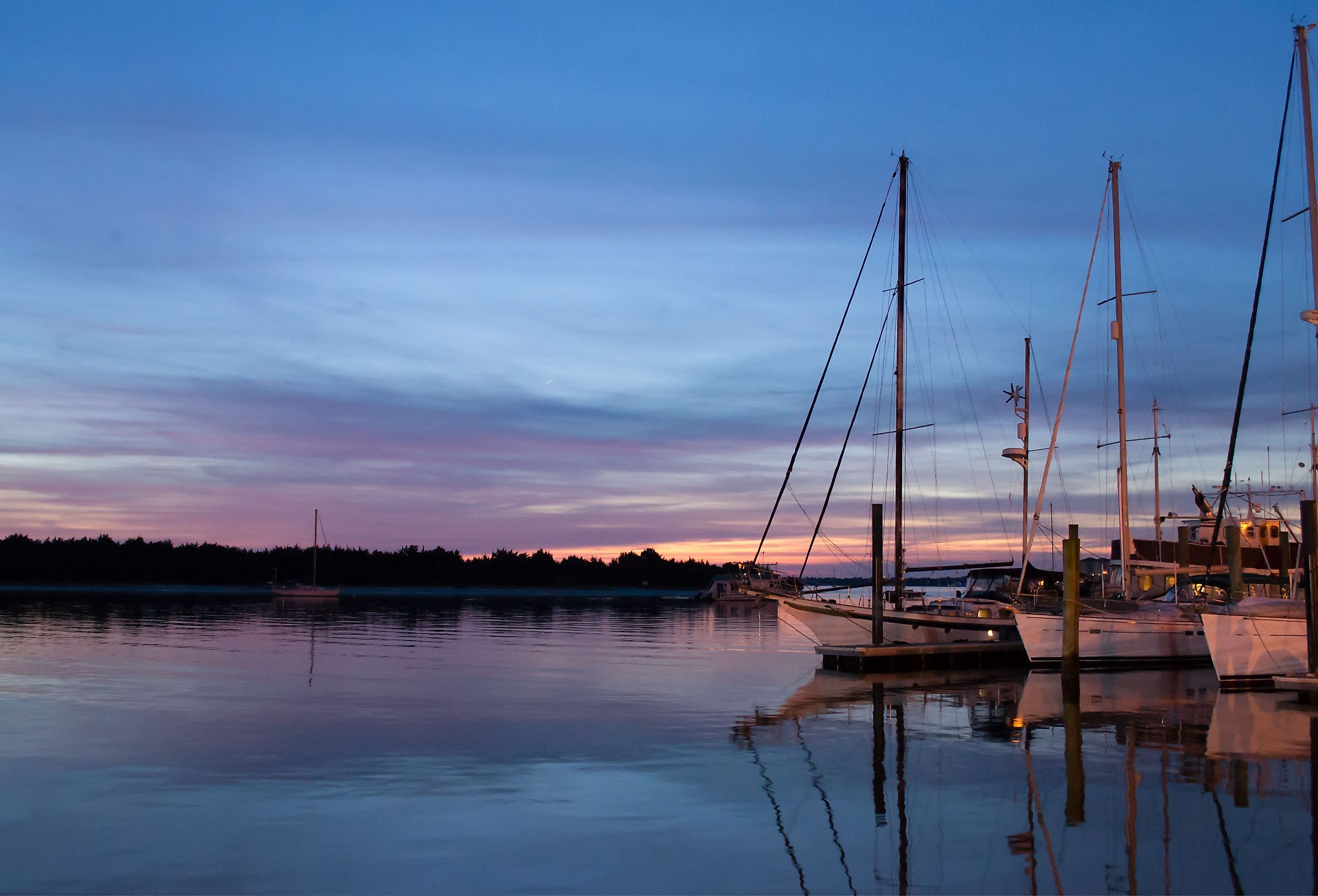 Sailboats sit quietly in calm waters in historic Beaufort, NC.