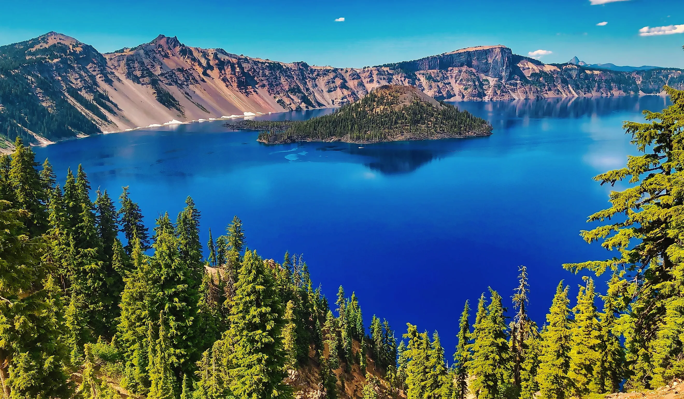 Wizard Island rises from the deep blue waters of Crater Lake in Crater Lake National Park, Oregon.